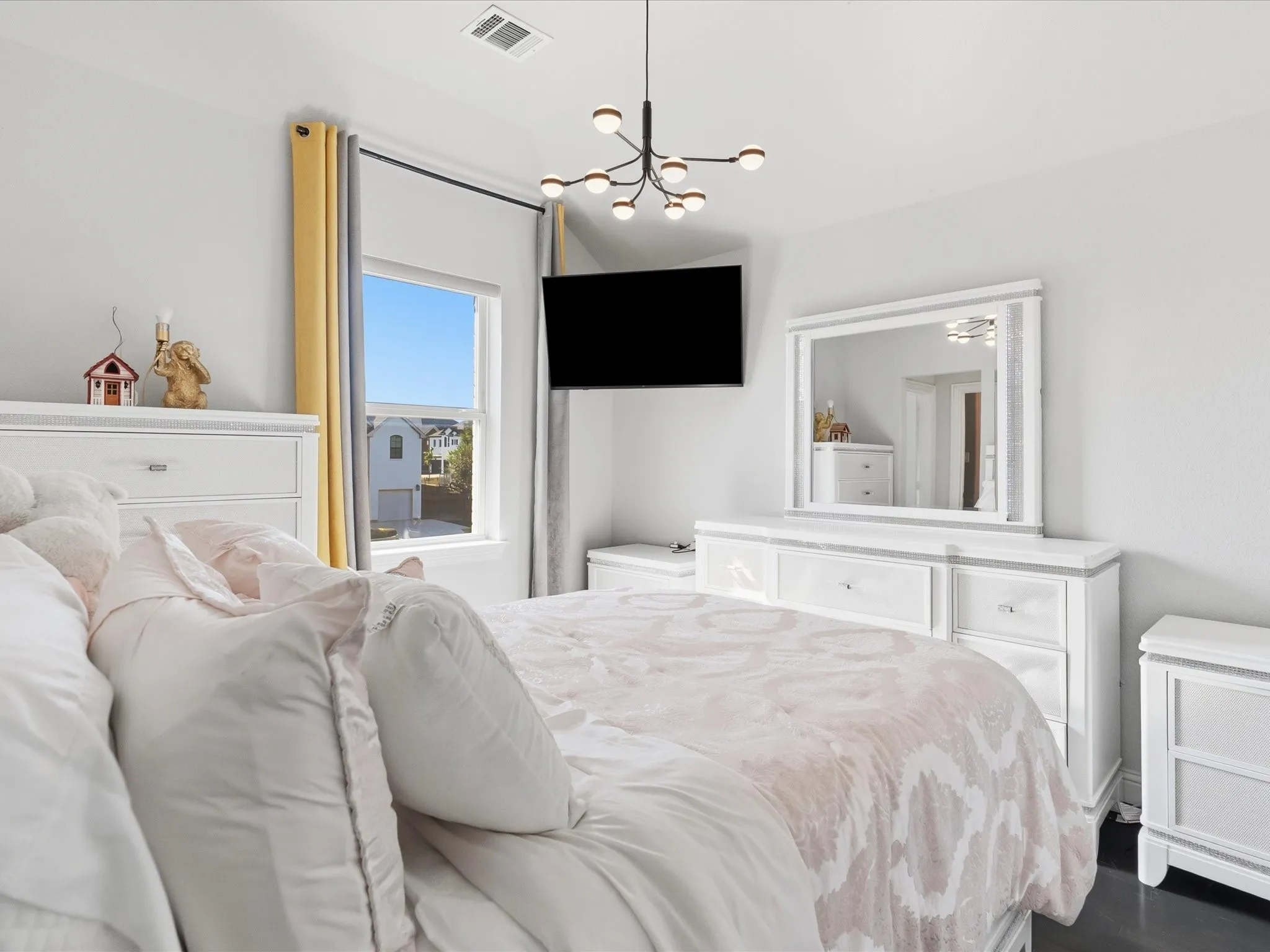 Recessed lighting, contemporary chandelier, large window, dark flooring, built-in wall mirror