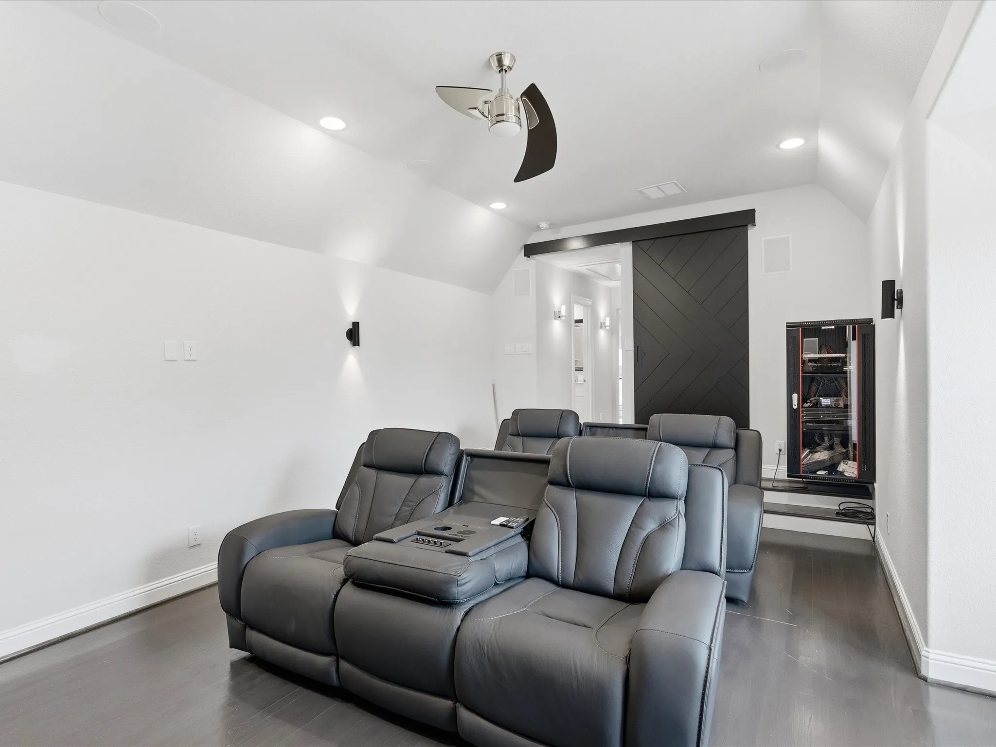 Vaulted ceiling with recessed lighting and a ceiling fan