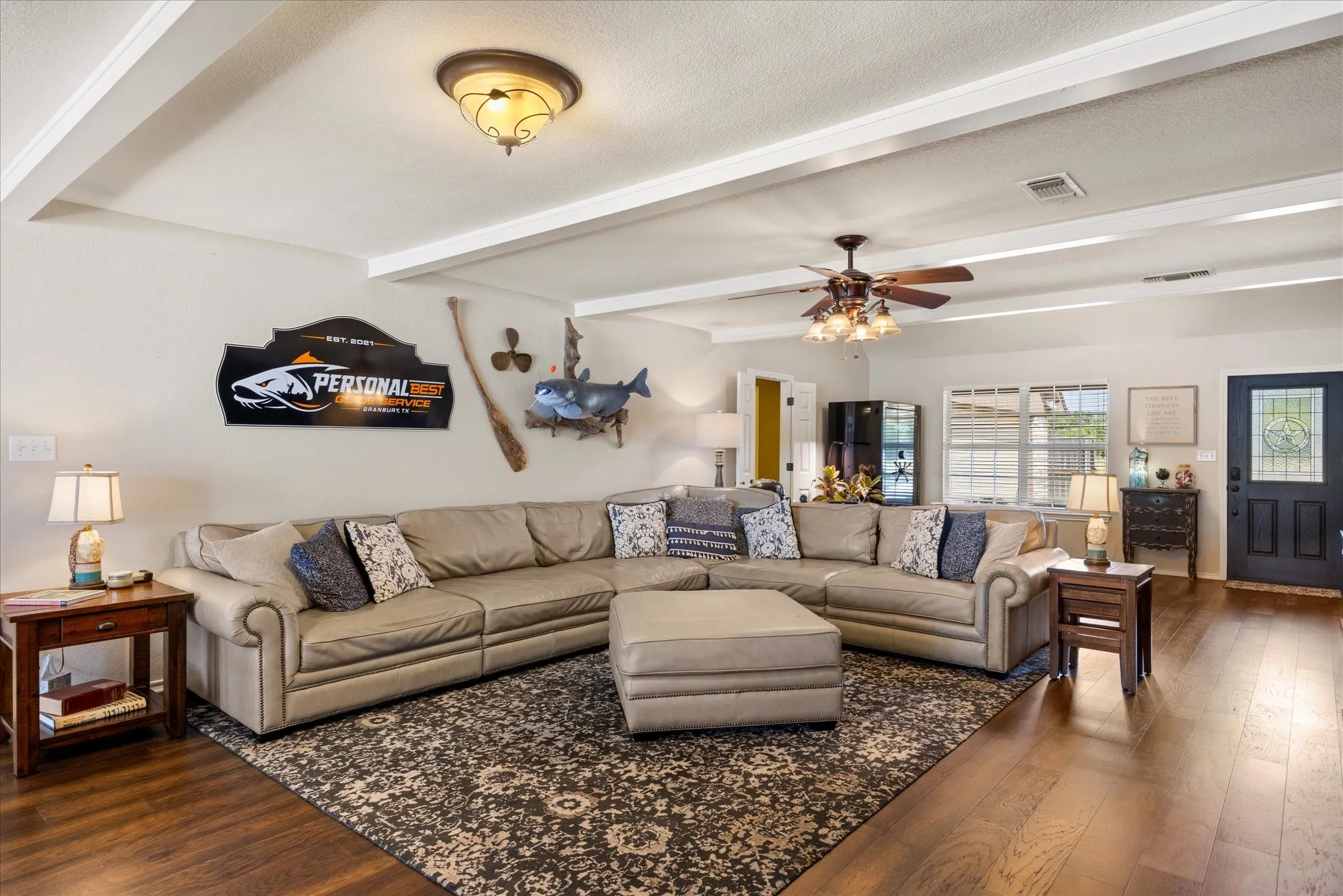 Spacious great room showcasing a coffered ceiling with recessed lighting, ceiling fan, and wood-finish flooring throughout