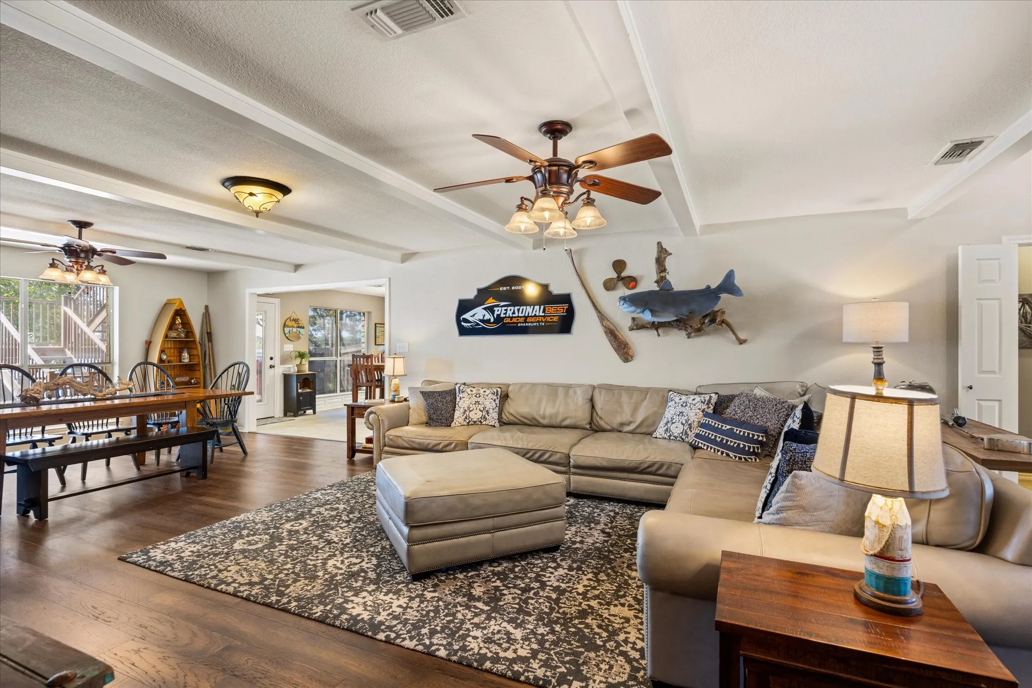 Beamed ceiling with recessed lighting, wood-finish flooring, ceiling fans with integrated lighting, white interior doors