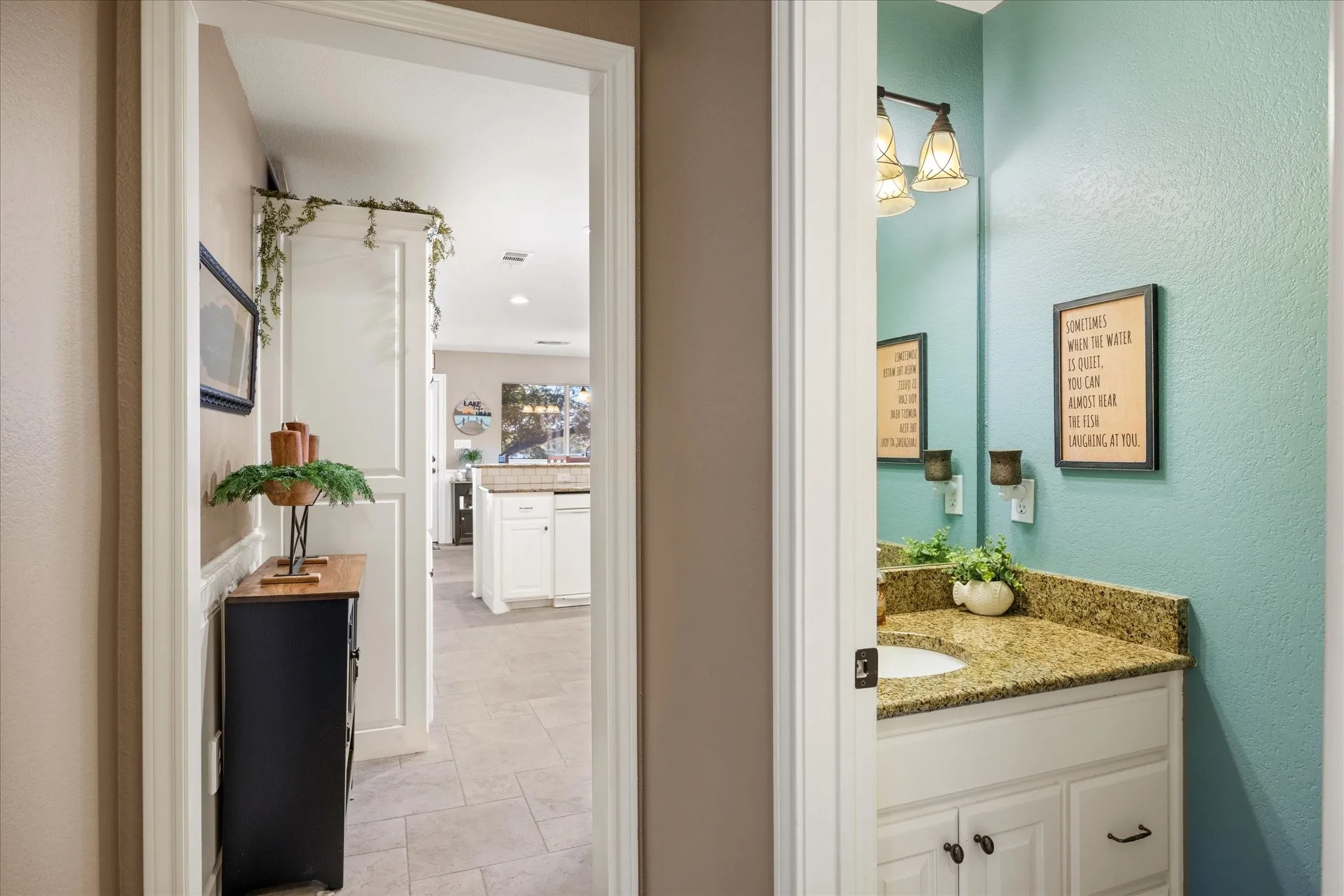 Dual bathroom vanities featuring white cabinetry with brushed nickel hardware, granite countertops, and integrated lighting