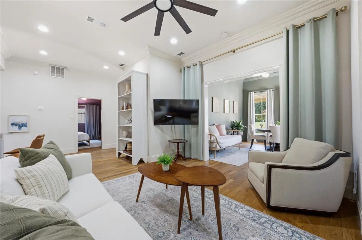 Recessed lighting, wood-finish flooring, built-in shelving, and a ceiling fan