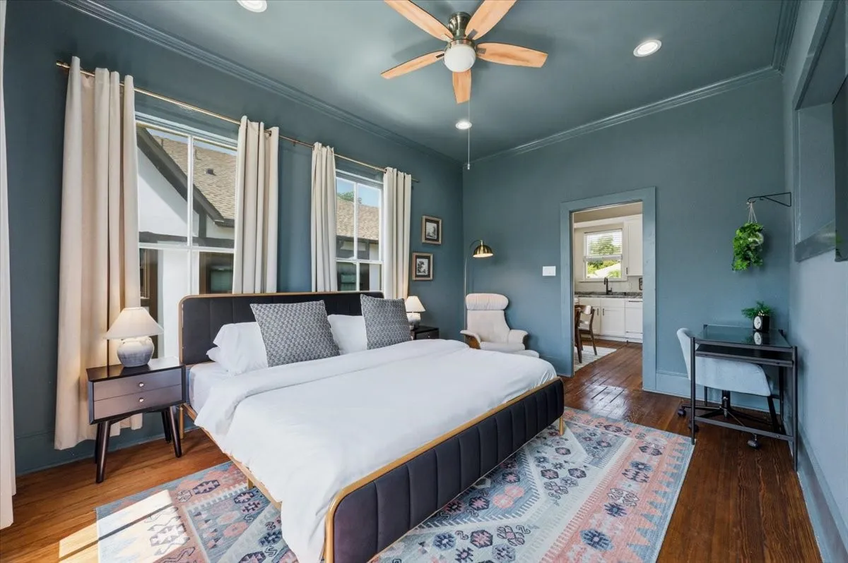 Hardwood flooring, painted crown molding, recessed lighting, ceiling fan, and double hung windows
