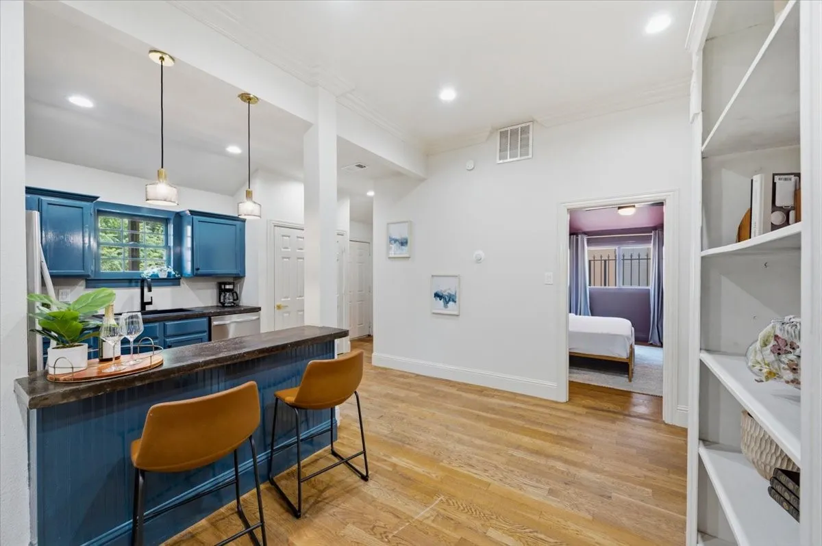 Kitchen with blue cabinetry, stainless steel appliances, and a breakfast bar