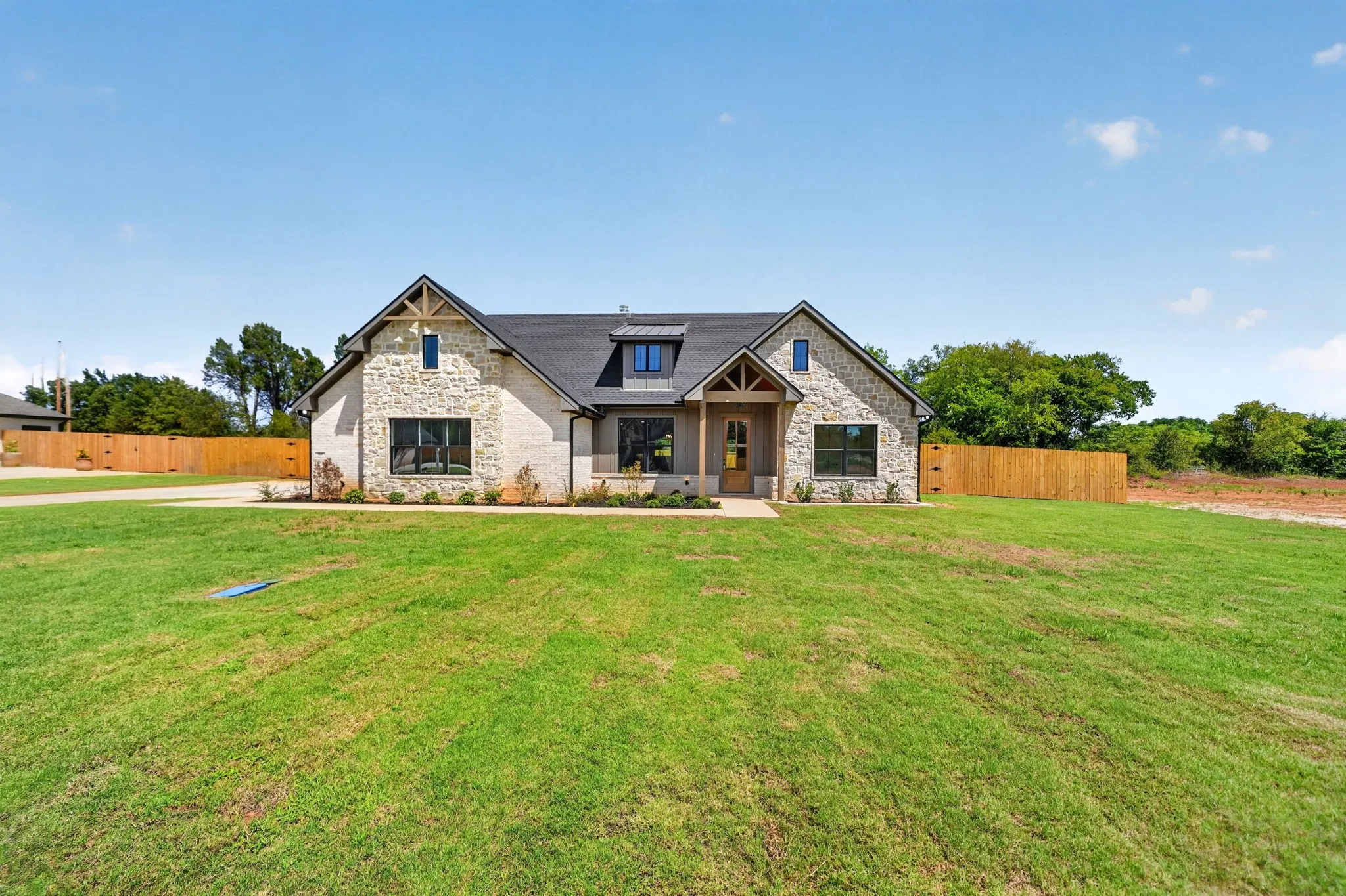 Stone and brick exterior with dark trim windows