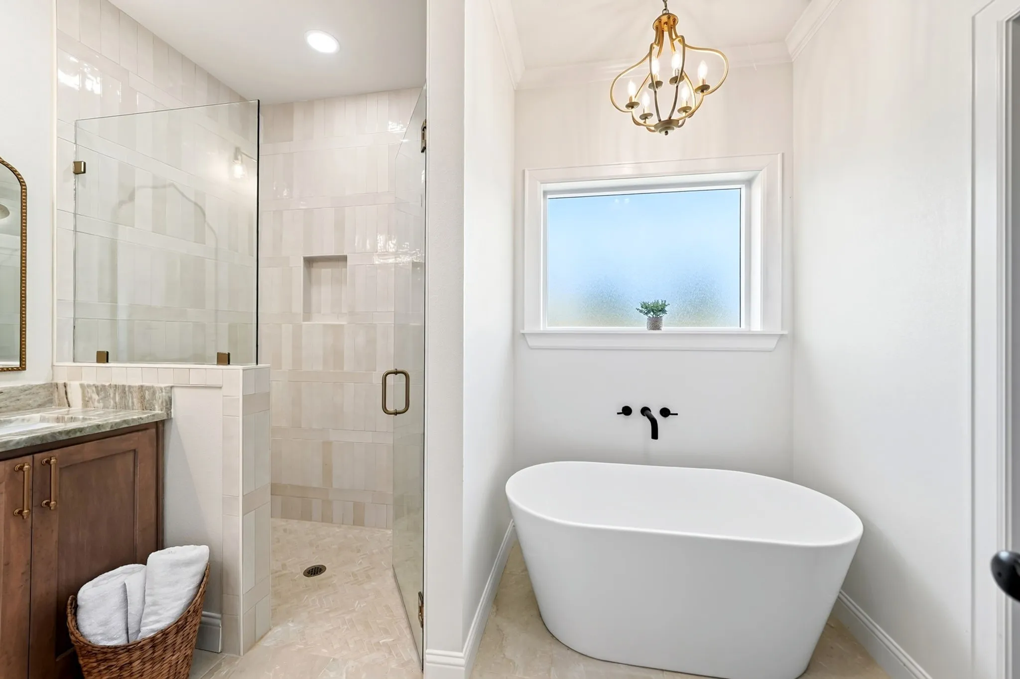 Freestanding soaking tub with a wall-mounted matte black faucet
