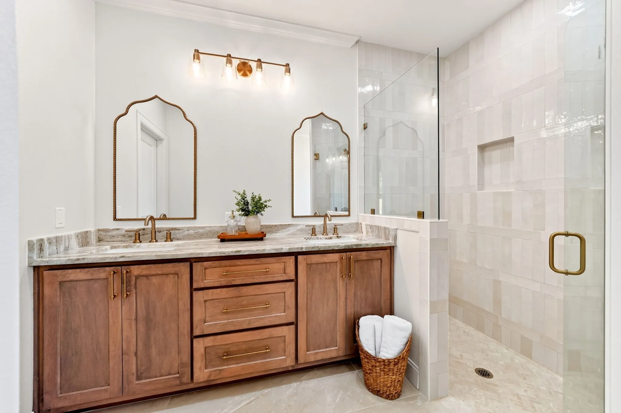 Dual vanity featuring wood cabinetry and light-toned countertops