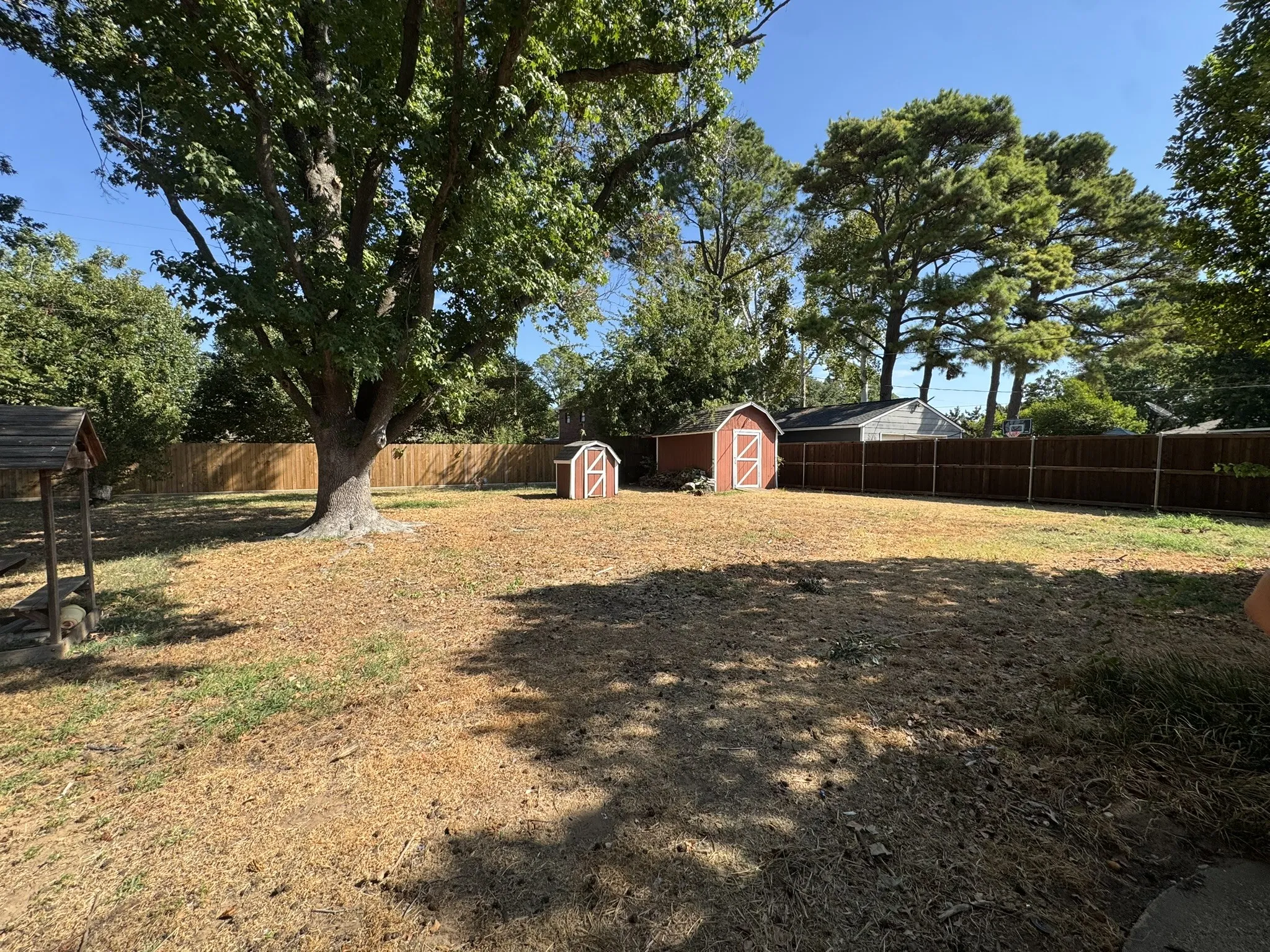 Back yard with well and storage buidling