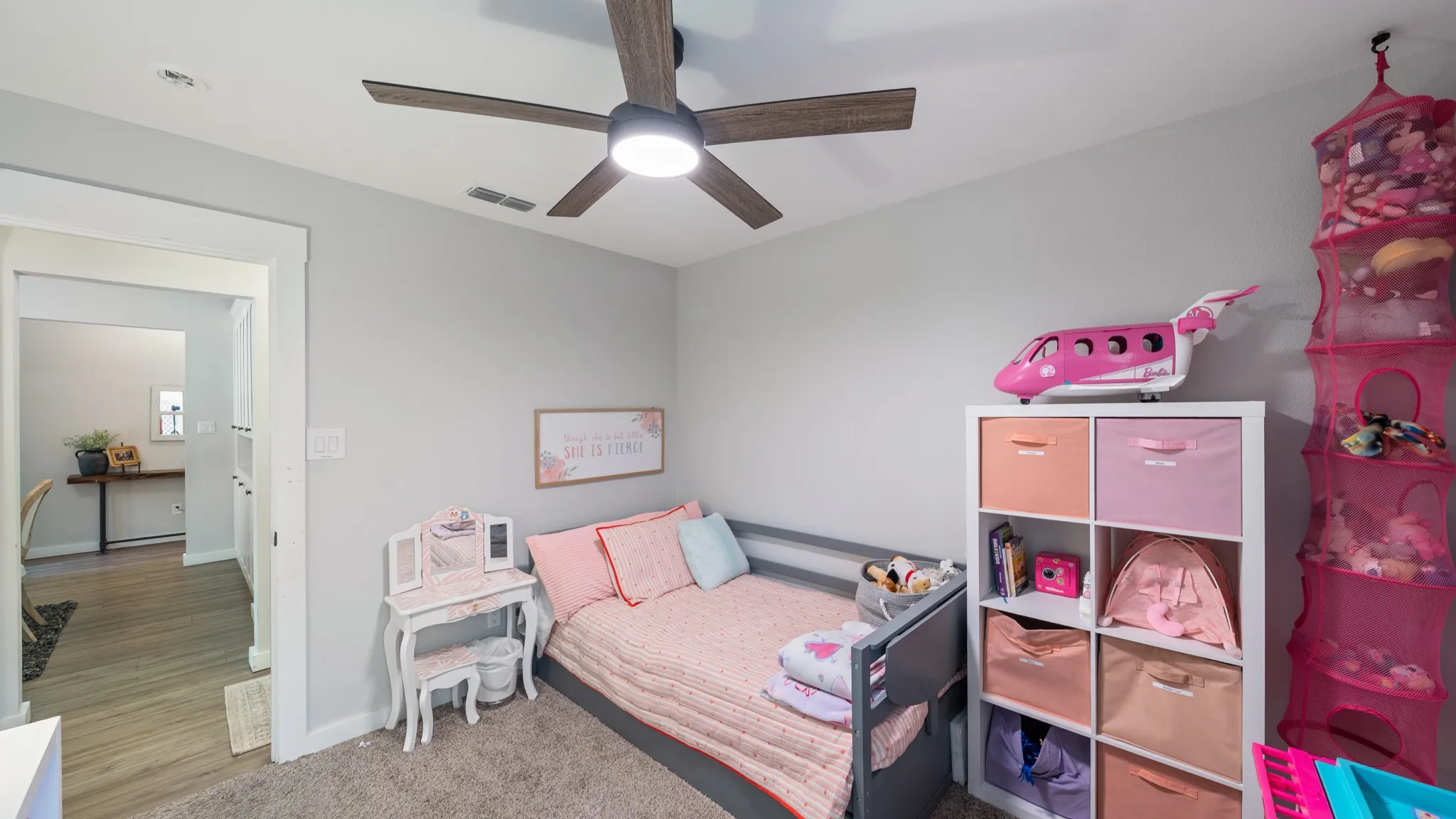 Recessed lighting, wood-finish ceiling fan, neutral wall paint, white trim, and a built-in storage unit