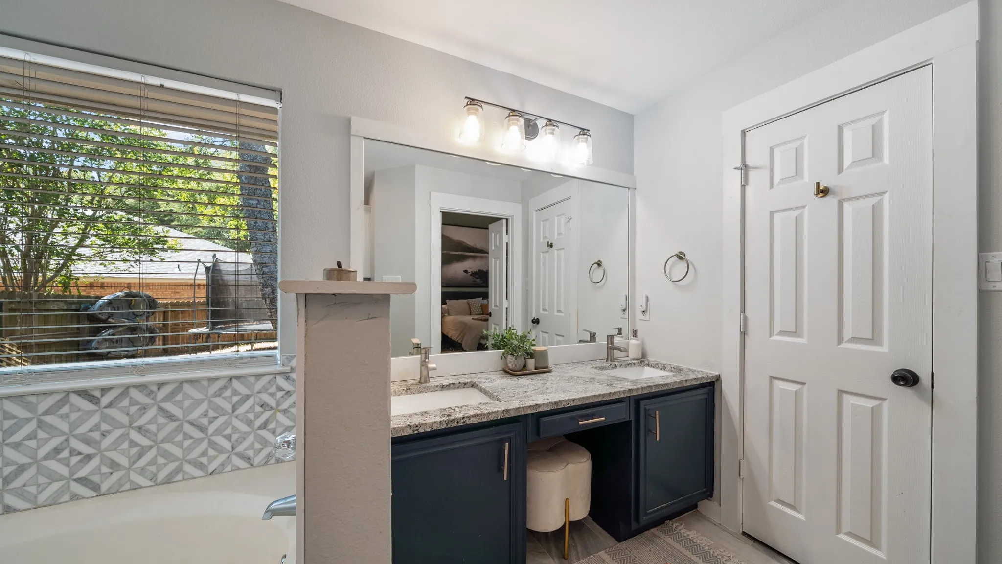 Dual vanity with granite countertops, undermount sinks, and a dark wood-finish cabinet