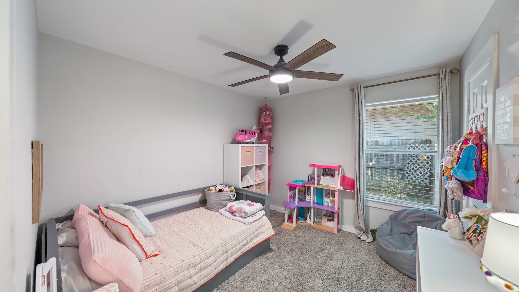 Recessed lighting, ceiling fan with wood-finish blades, and a window with blinds and drapes