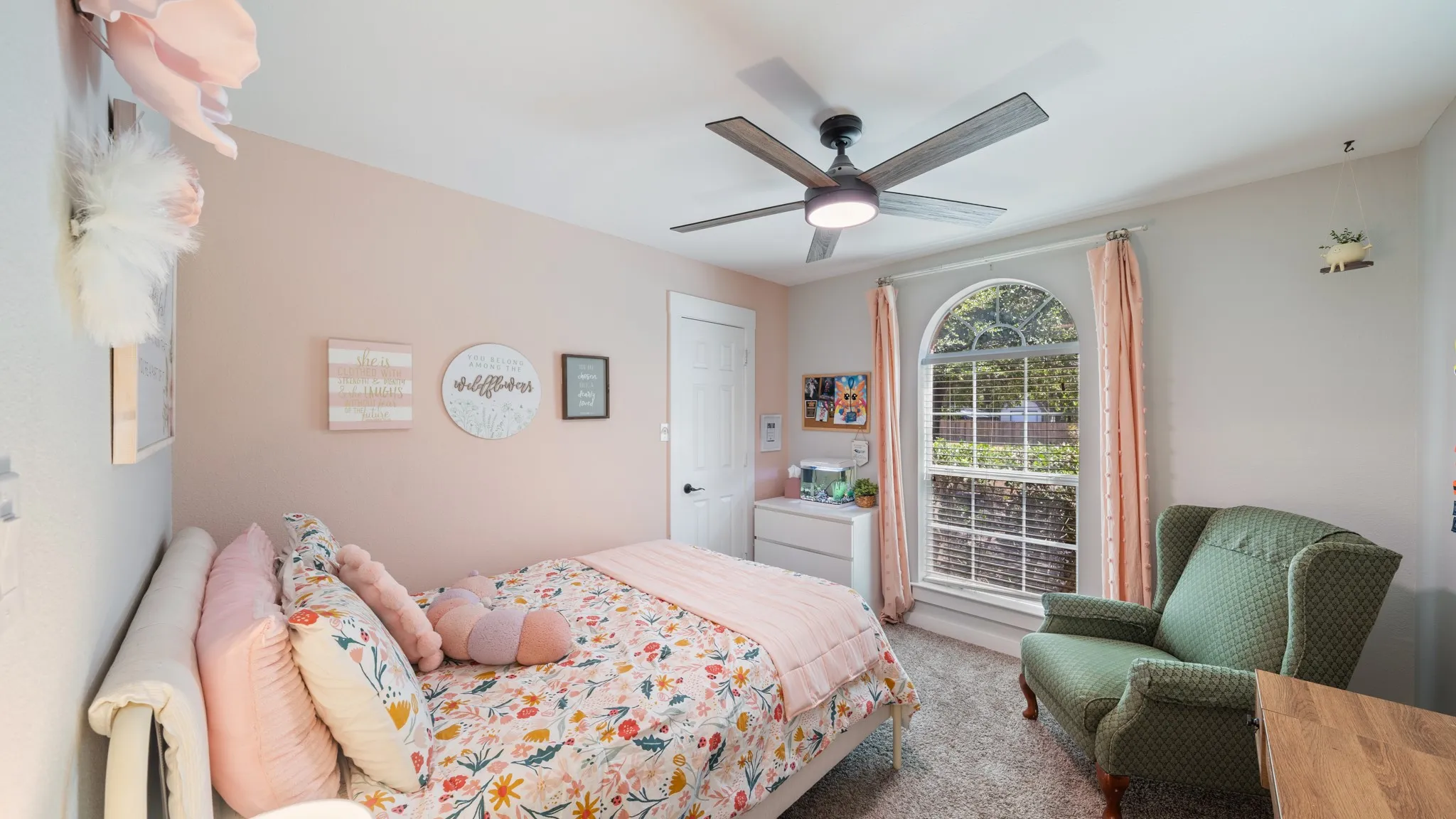 Arched window, ceiling fan with integrated lighting, wood-finish flooring, white door, and neutral wall tones