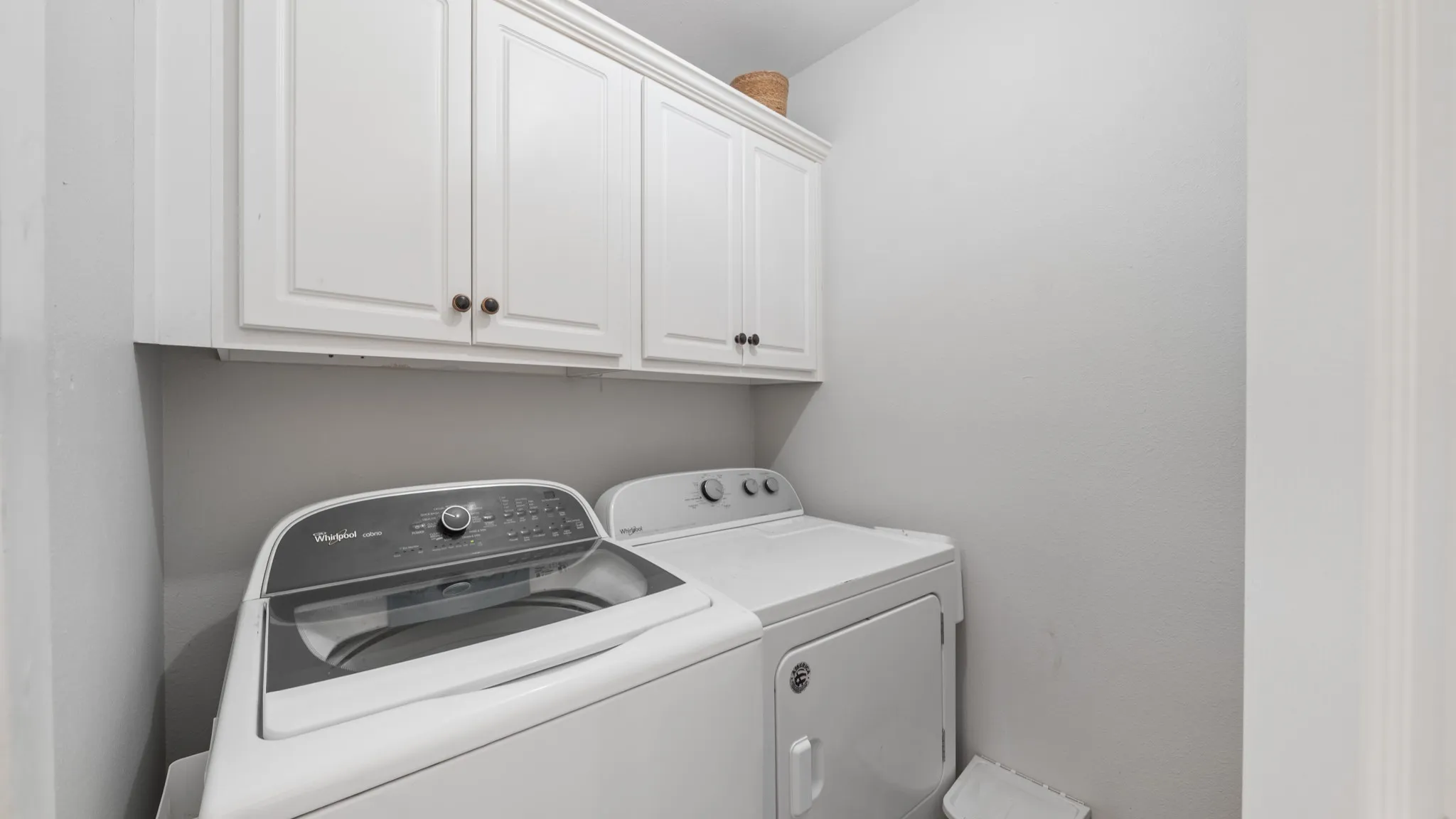 White shaker-style cabinetry with dark hardware