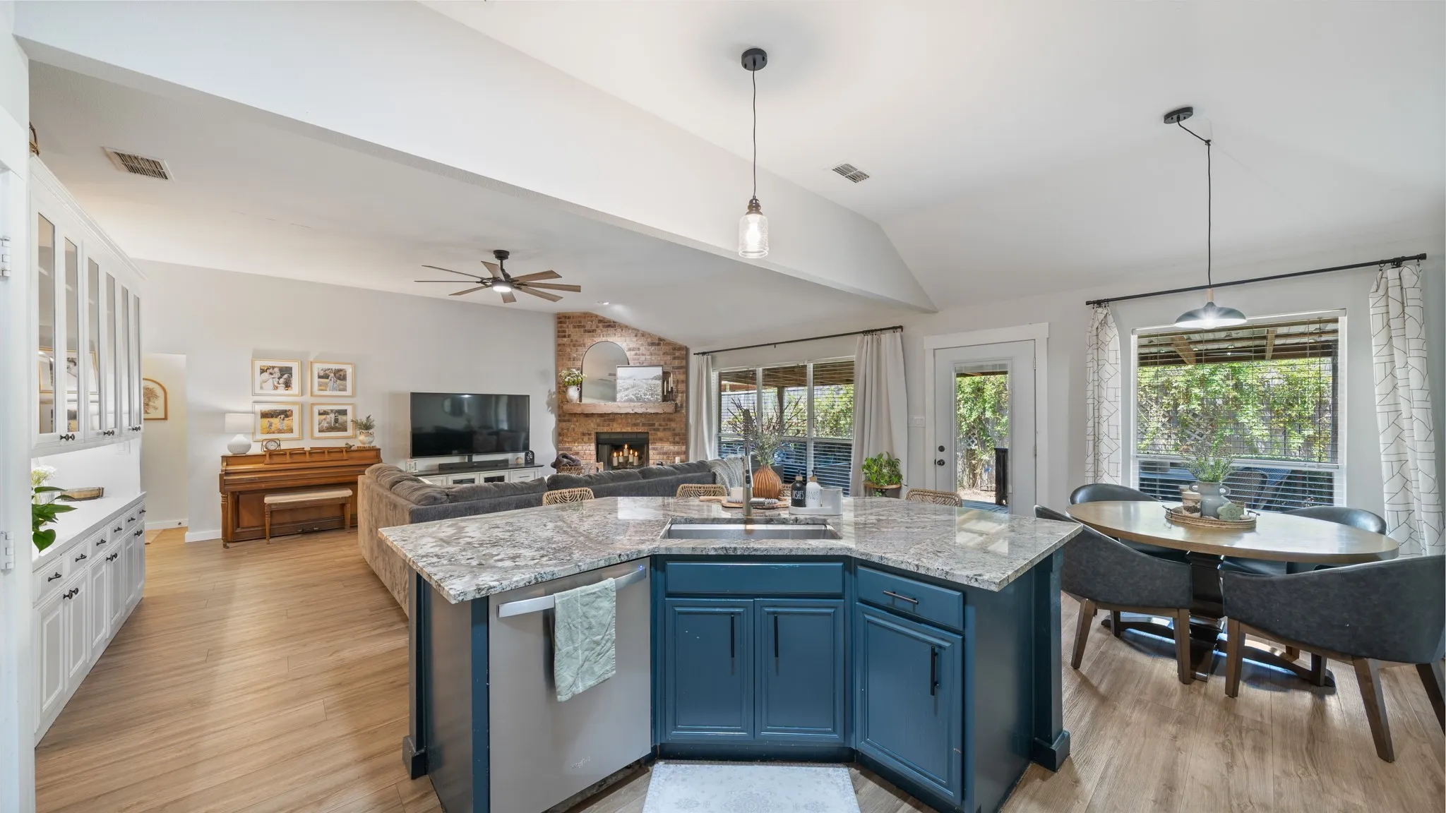 Kitchen island with a built-in sink and stone-finish countertop