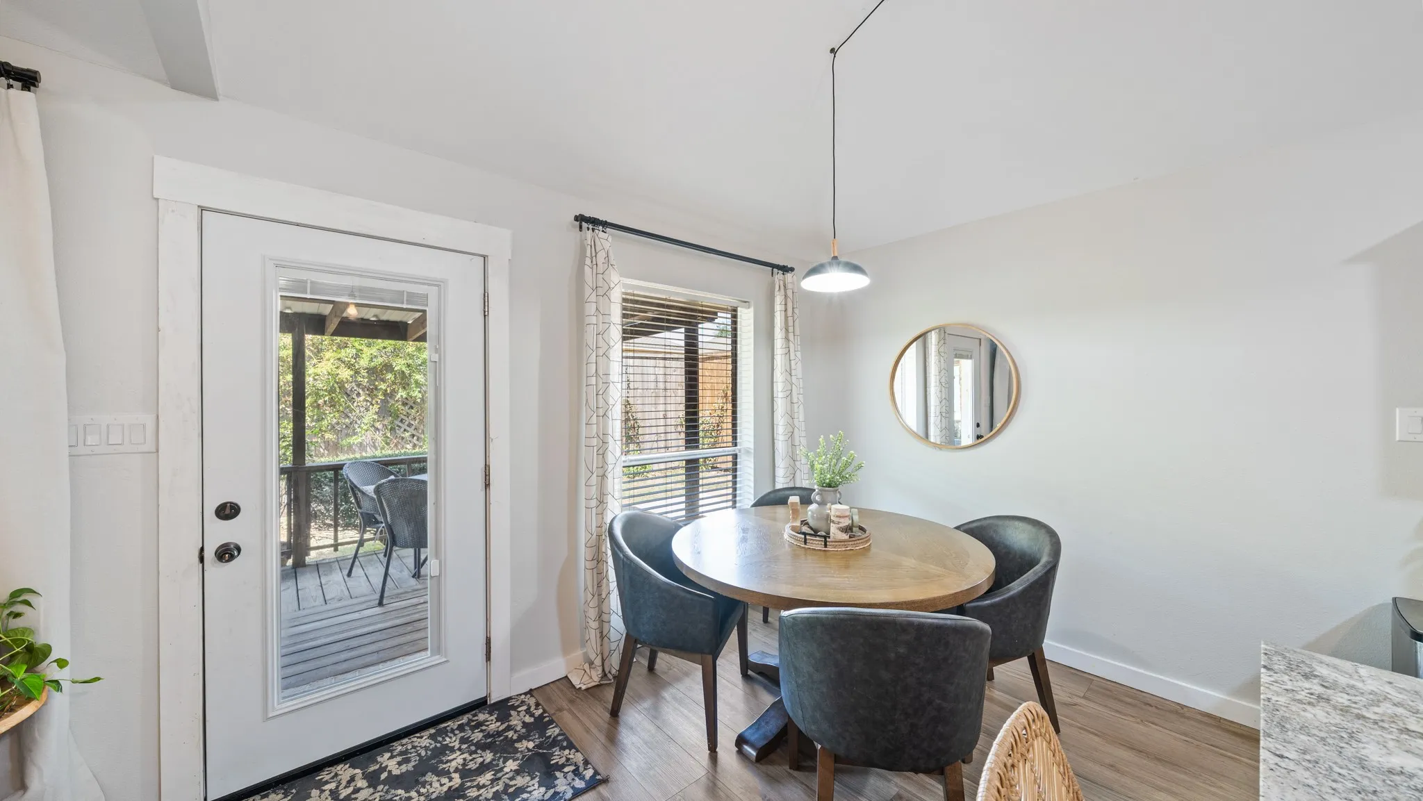 Glass-paneled exterior door, wood-finish flooring, recessed lighting, and a window with blinds