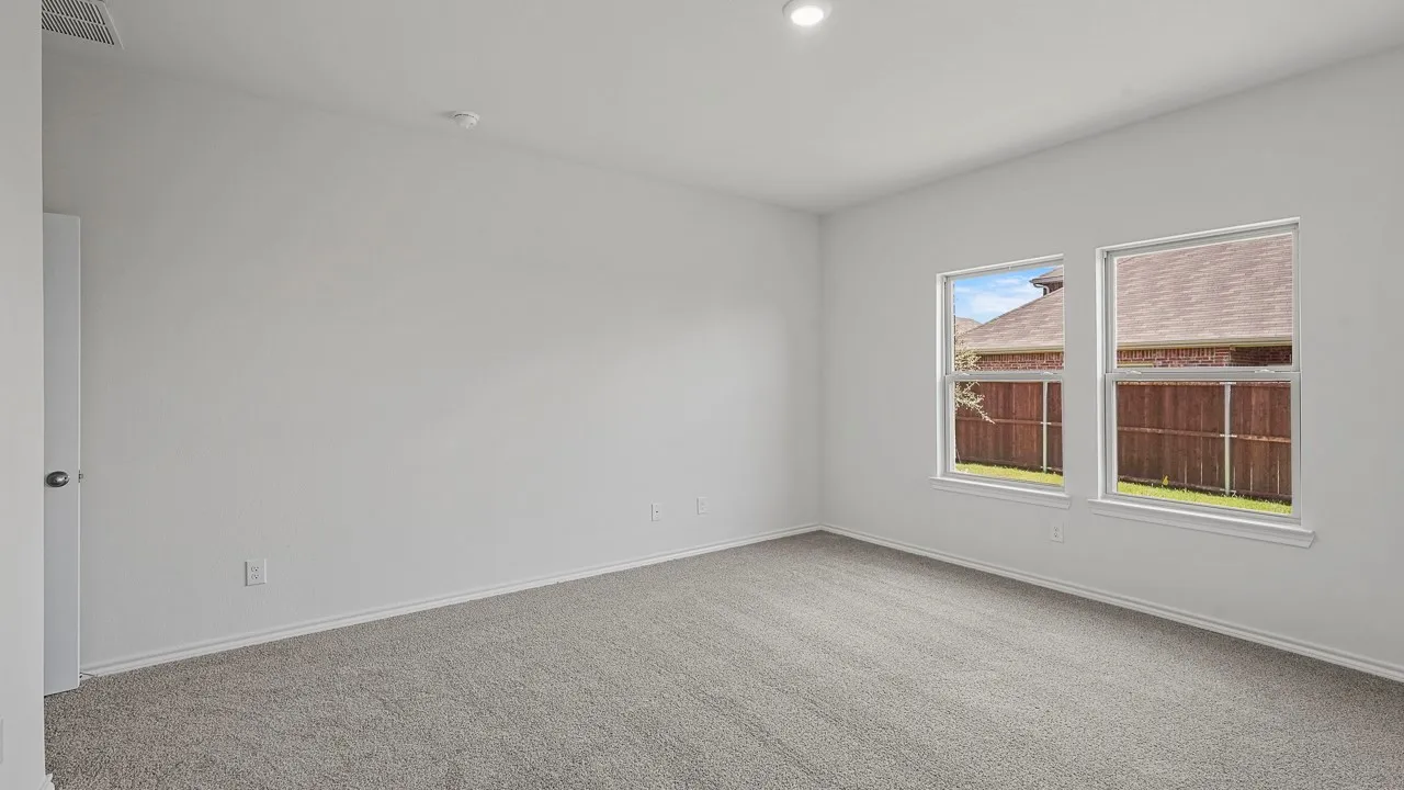 Recessed ceiling lighting, light gray carpet flooring, white walls, and two double-hung windows