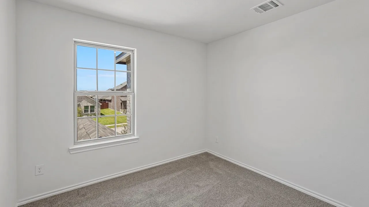 Double-hung window with white trim, gray carpet flooring, and white painted walls