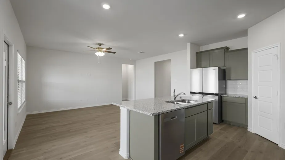 Open-concept living space with wood-finish flooring, recessed lighting, and a ceiling fan