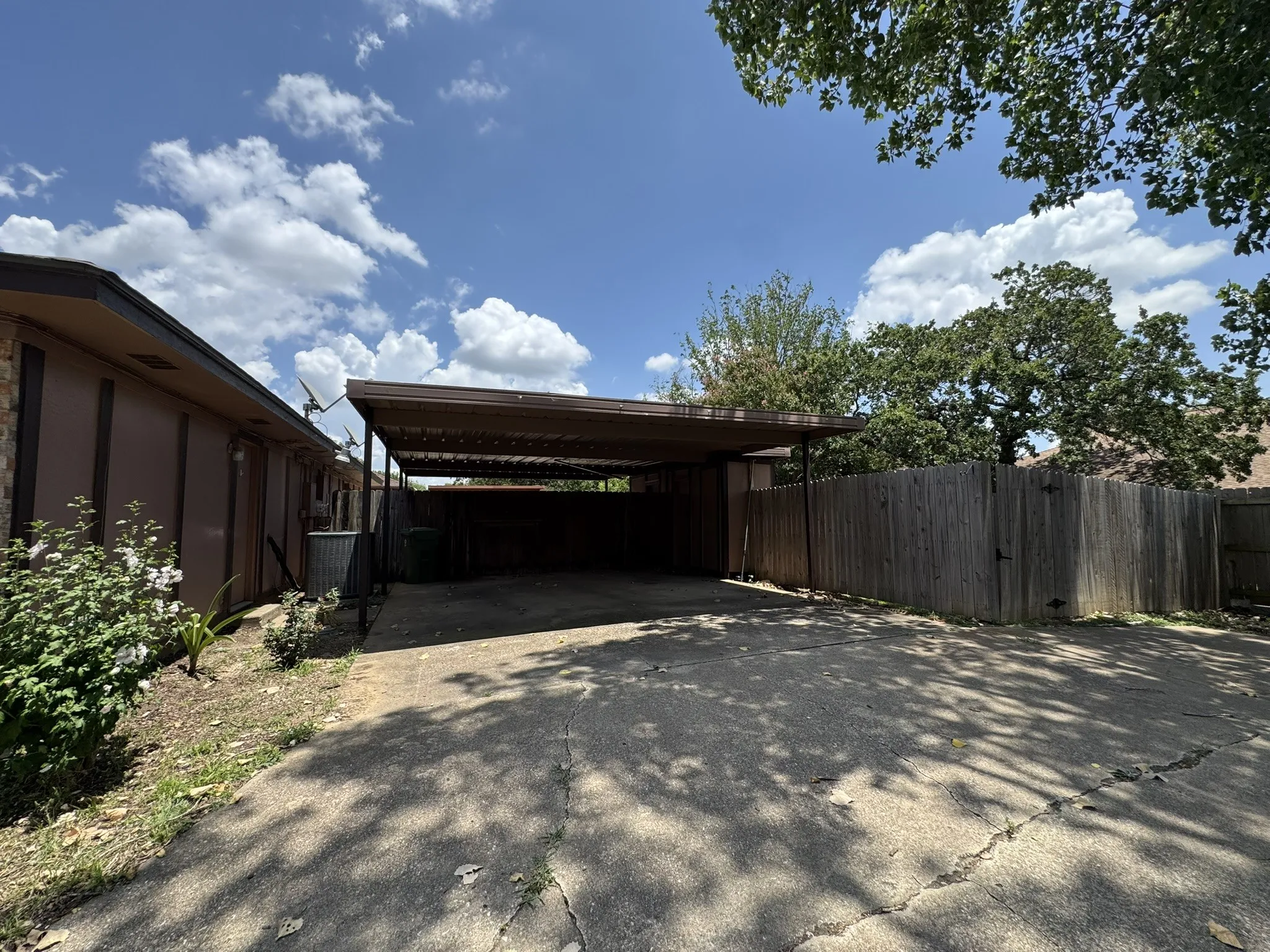 View of parking featuring concrete driveway