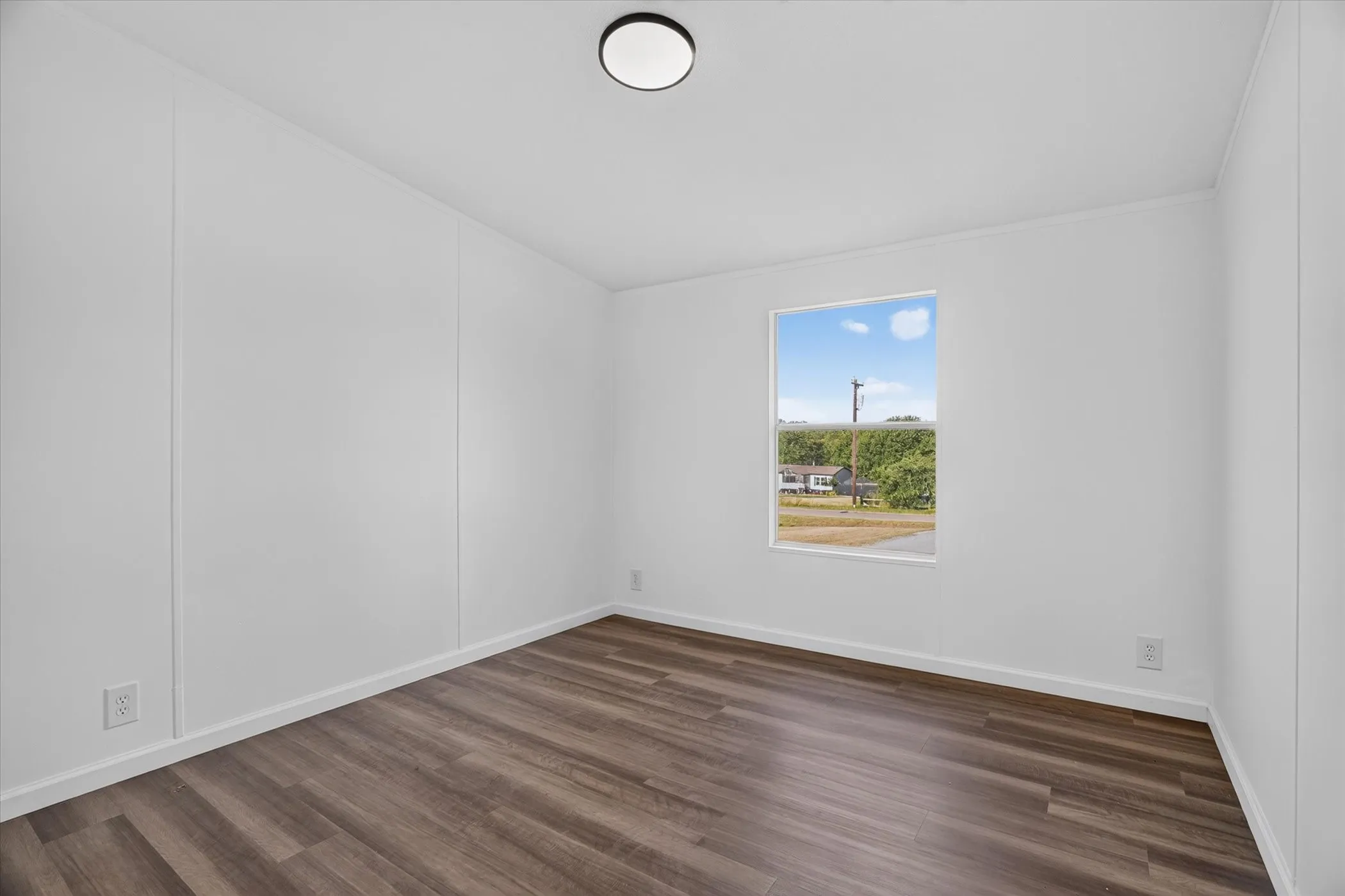 Recessed ceiling lighting, wood-finish flooring, and white walls