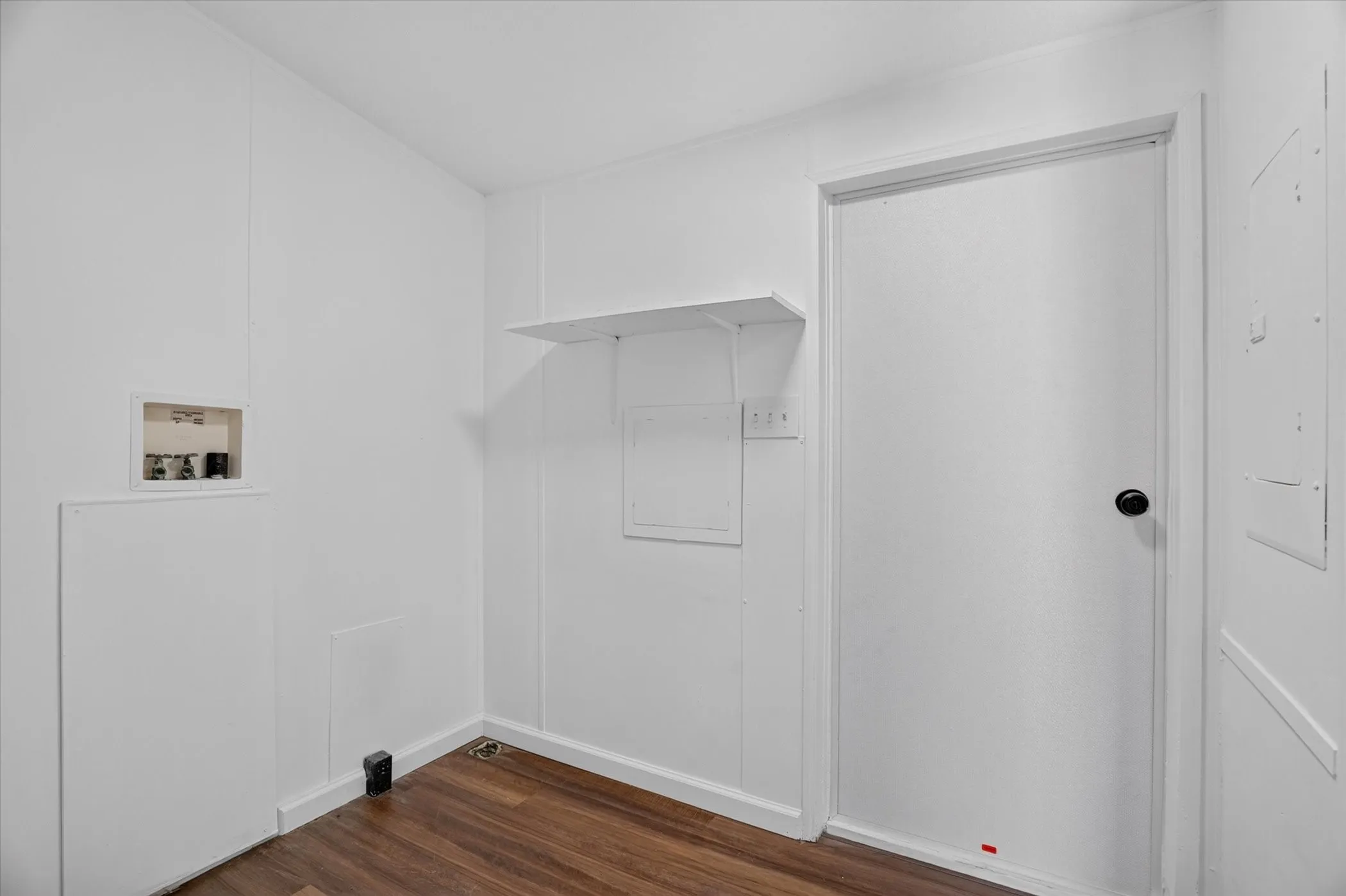 Wood-finish flooring with white wall paneling