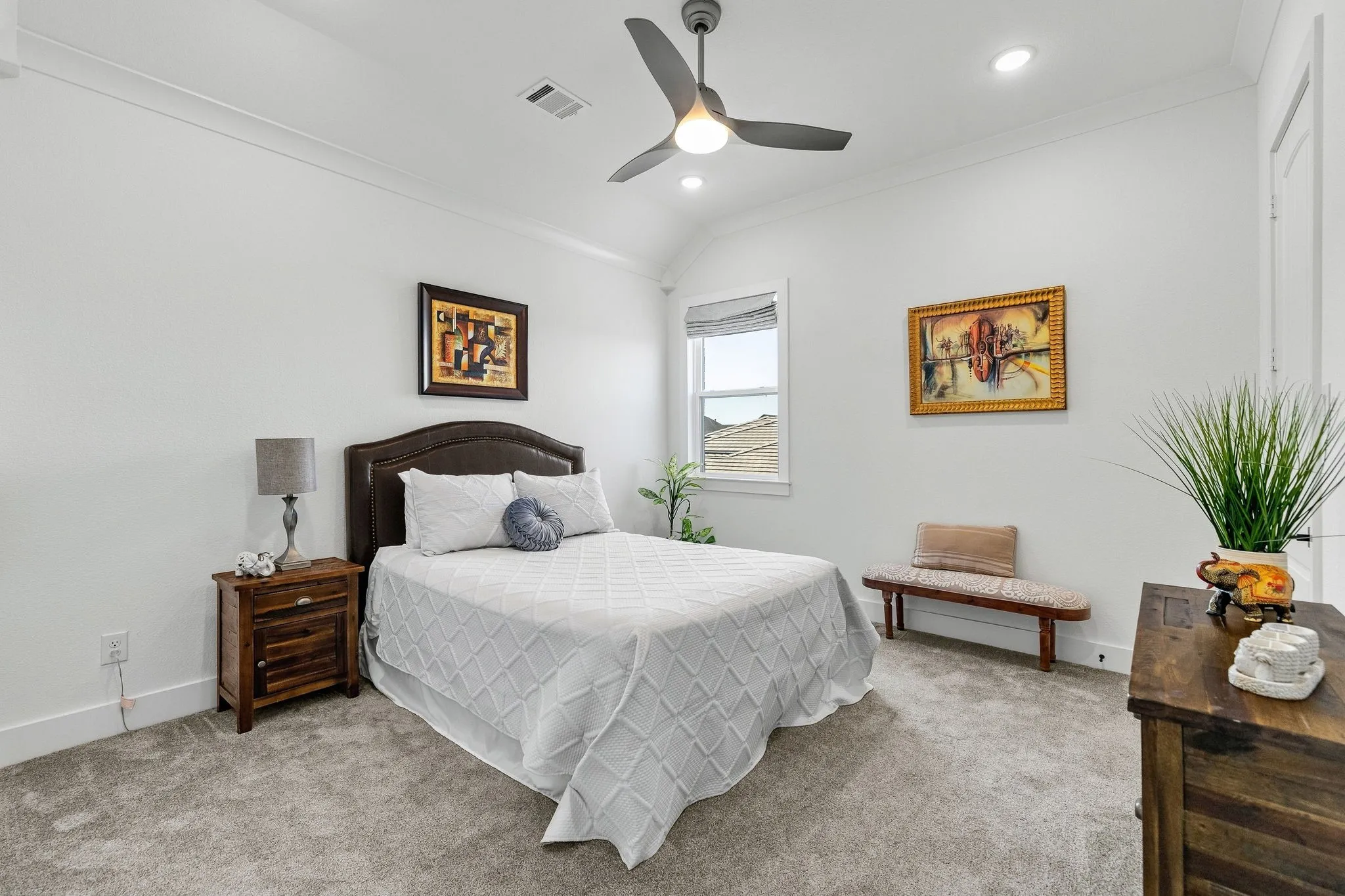 Plush carpeted flooring, a ceiling fan with integrated lighting, and crown molding