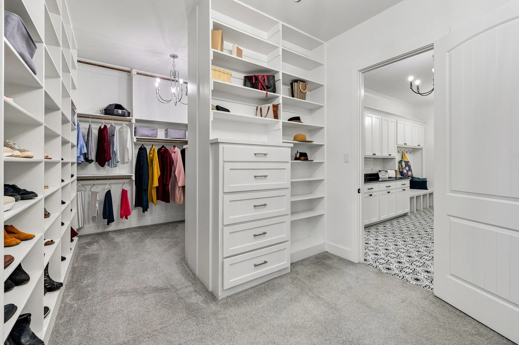 Custom closet system featuring extensive shelving, built-in drawer storage, and hanging rods