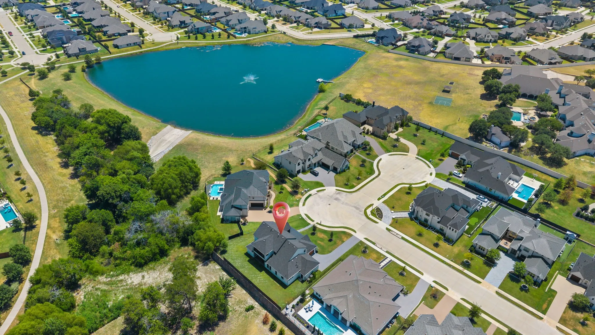 Aerial perspective highlighting a cul-de-sac location with a nearby water feature and surrounding residences