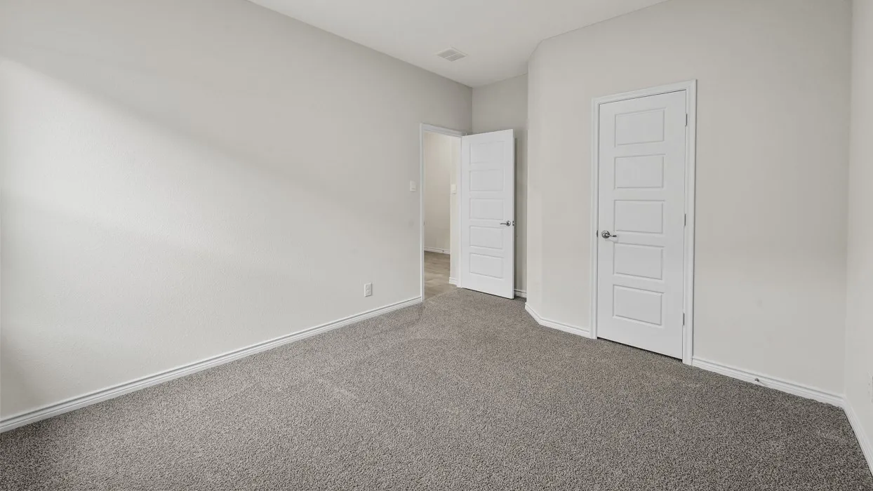 Neutral wall finishes with white trim, gray carpeting, and white paneled doors
