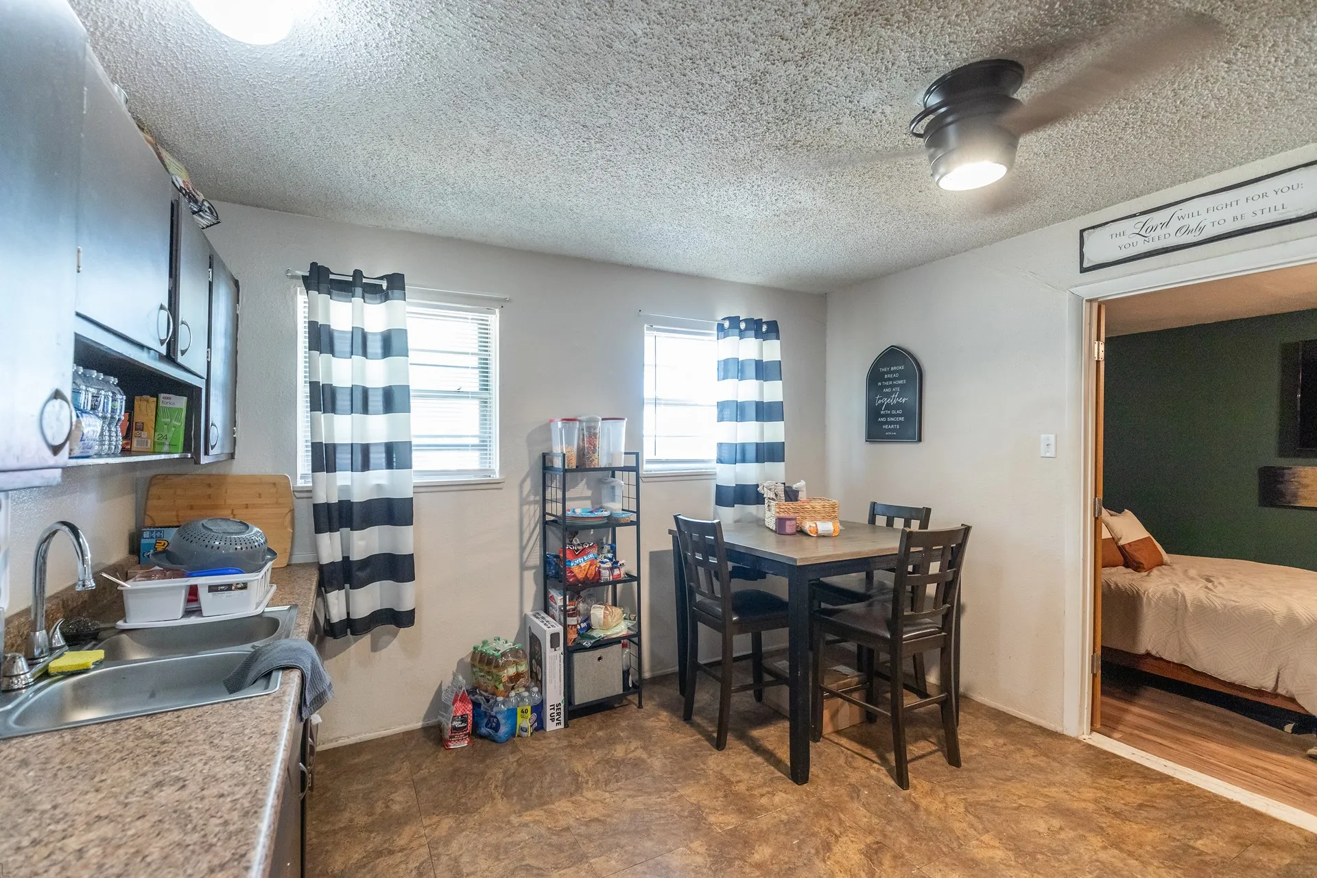 Kitchen with laminate countertops, wood-finish flooring, and a ceiling fan