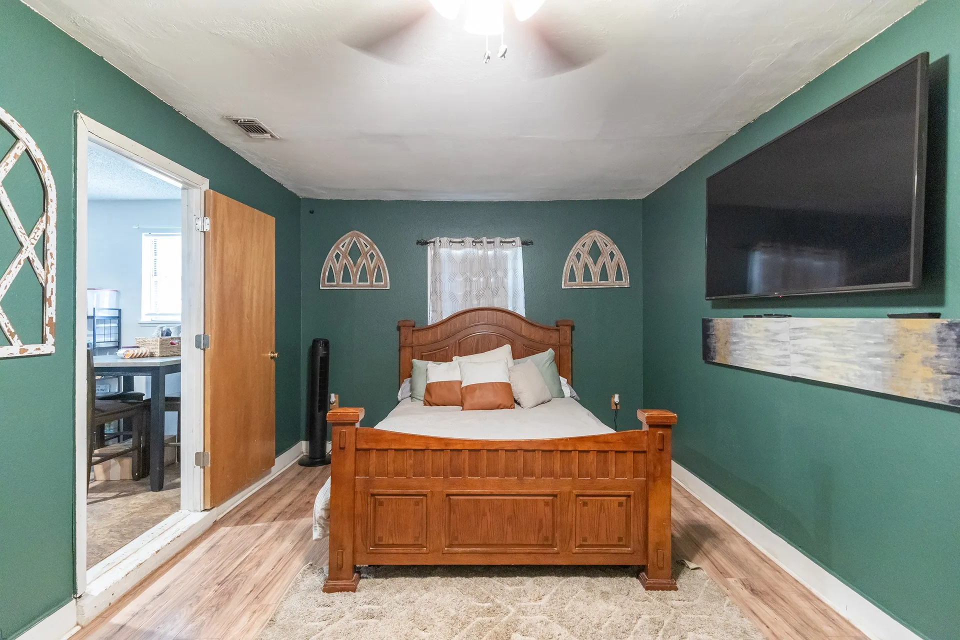 Wood-finish flooring throughout, complemented by a light-colored area rug