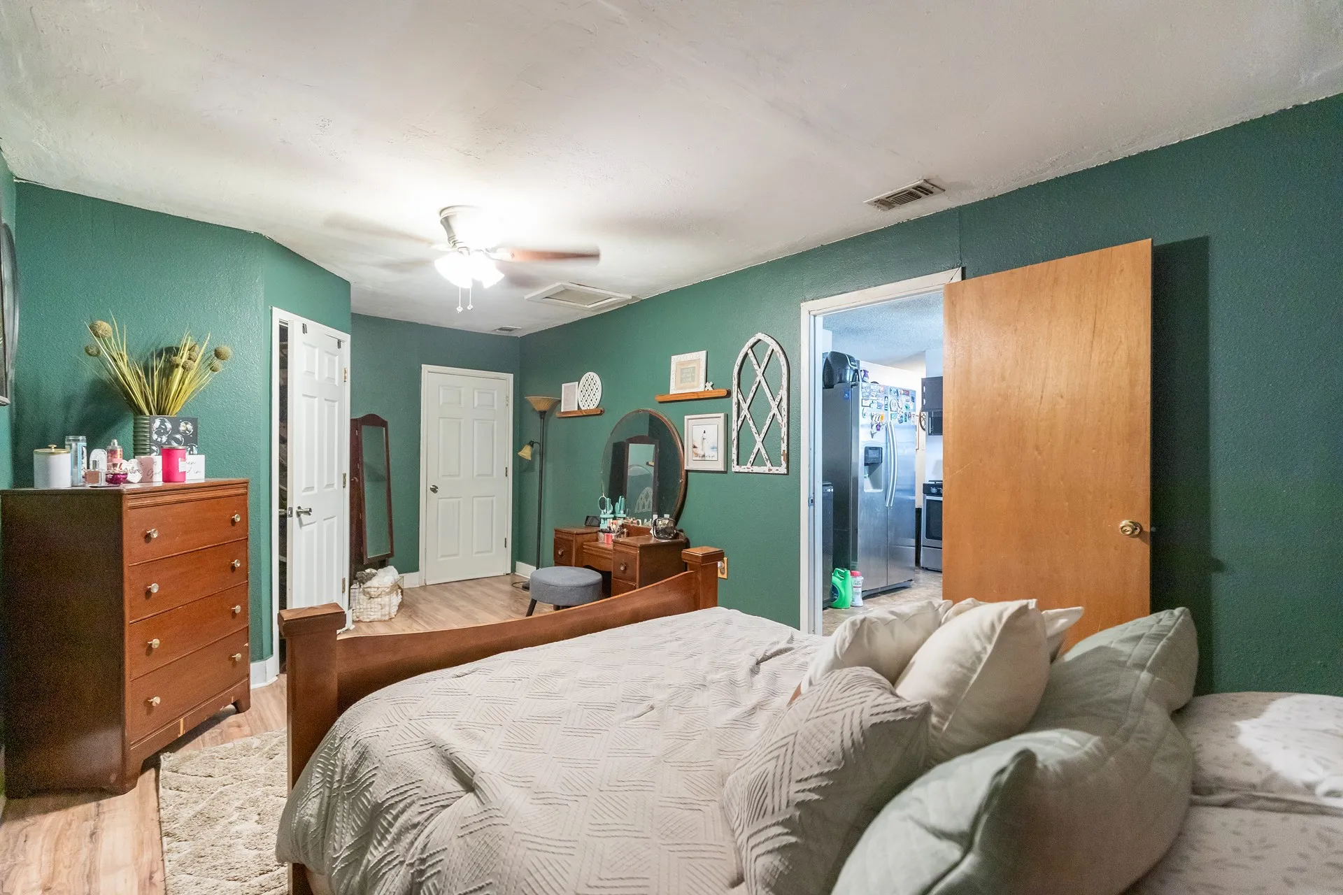 Wood-finish flooring, ceiling fan, and solid panel doors