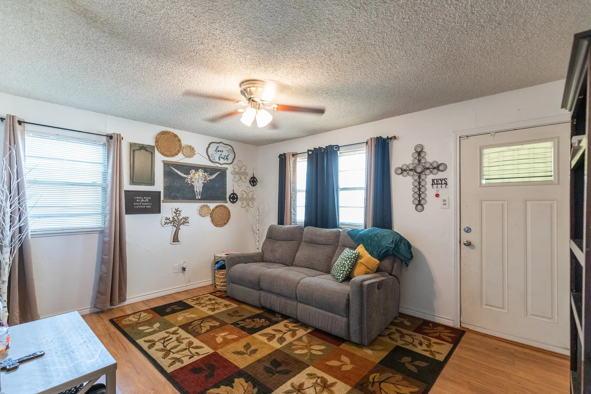 Recessed lighting, ceiling fan, wood-finish flooring, multiple windows, and a panel door