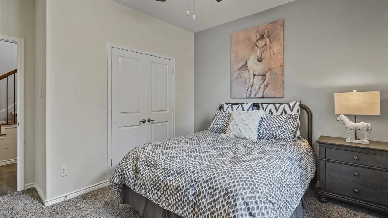 Neutral paint colors, a ceiling fan, and carpeted flooring