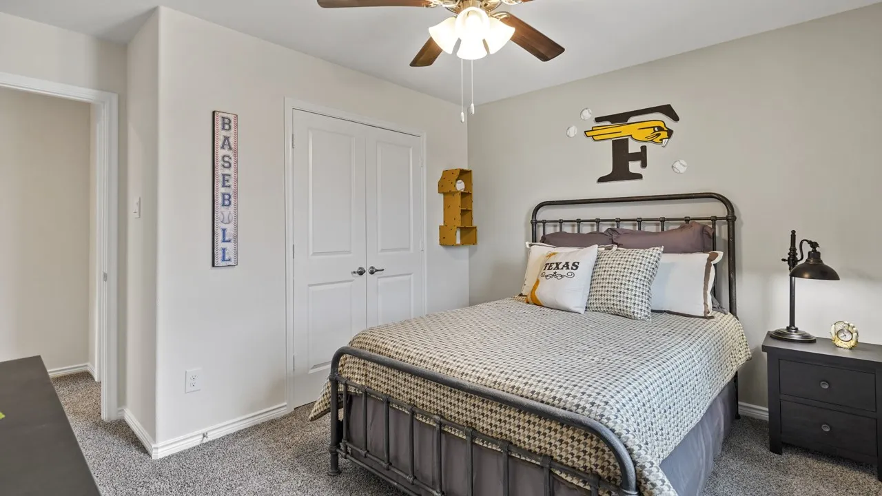 Carpeted room featuring a ceiling fan with integrated lighting, double closet doors, and light-toned wall paint