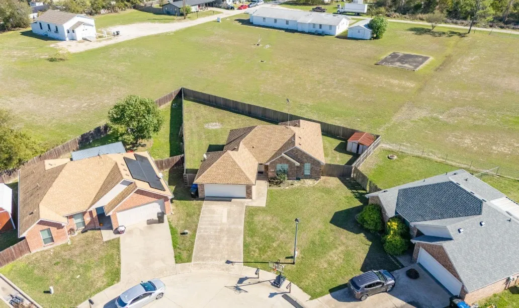 Single-story residence with a multi-gabled roof, attached garage, and paved driveway