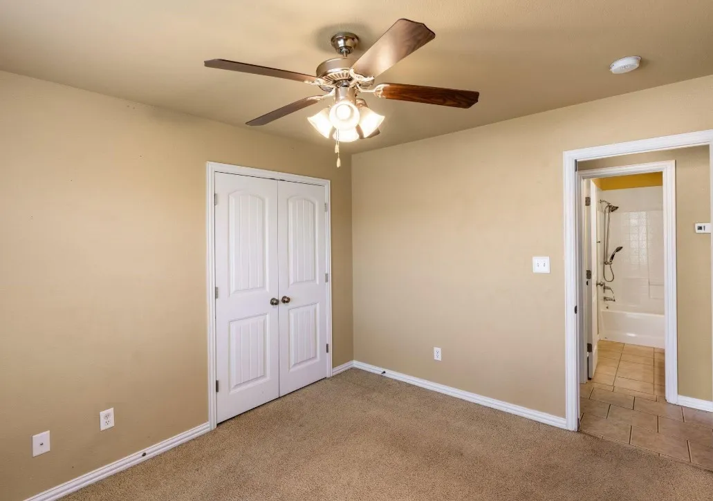 Recessed lighting, ceiling fan with light fixture, carpeted flooring, double bi-fold closet doors, and tile flooring in the open doorway