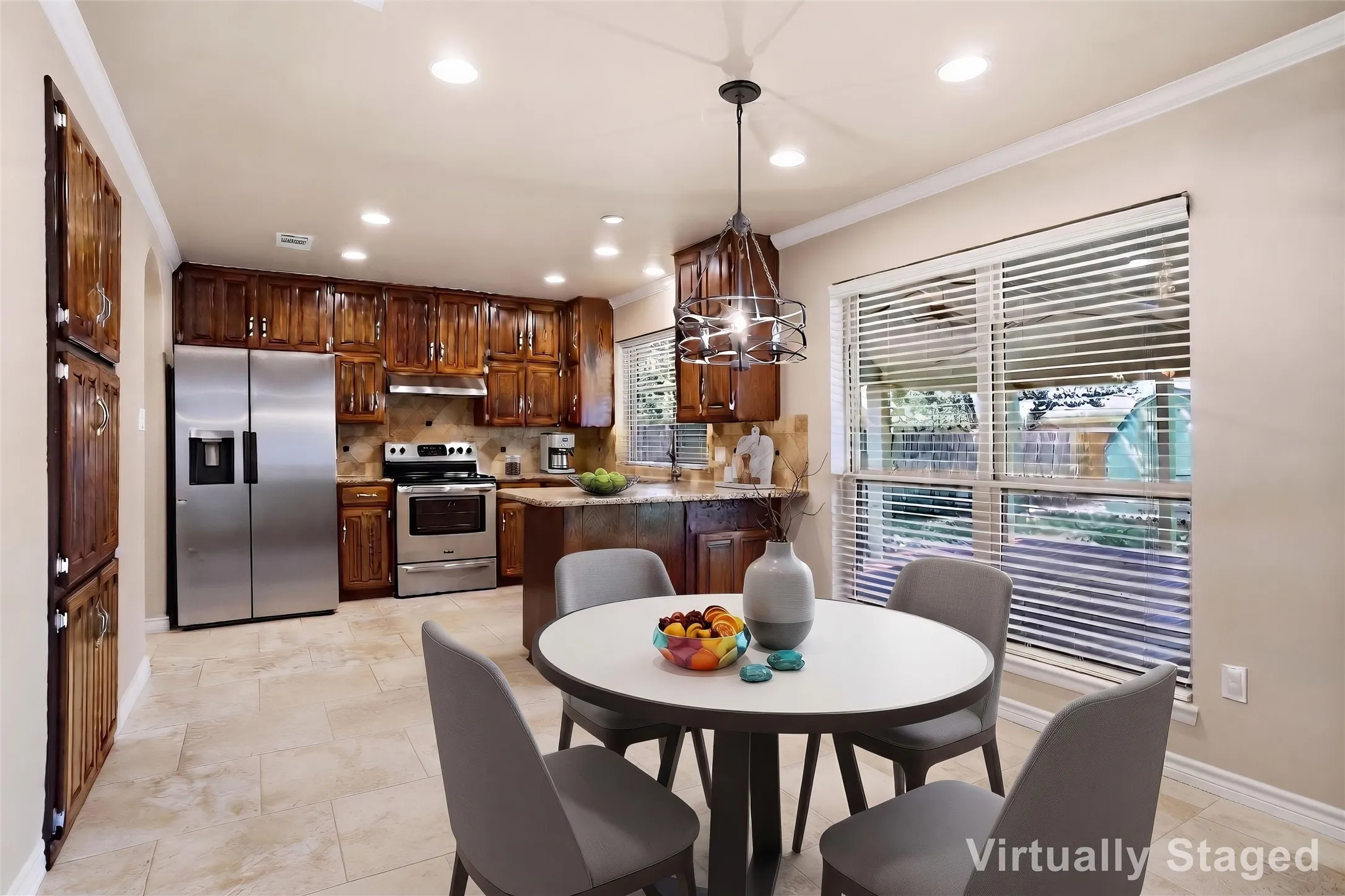Kitchen with wood cabinetry, stainless steel appliances, and tile flooring