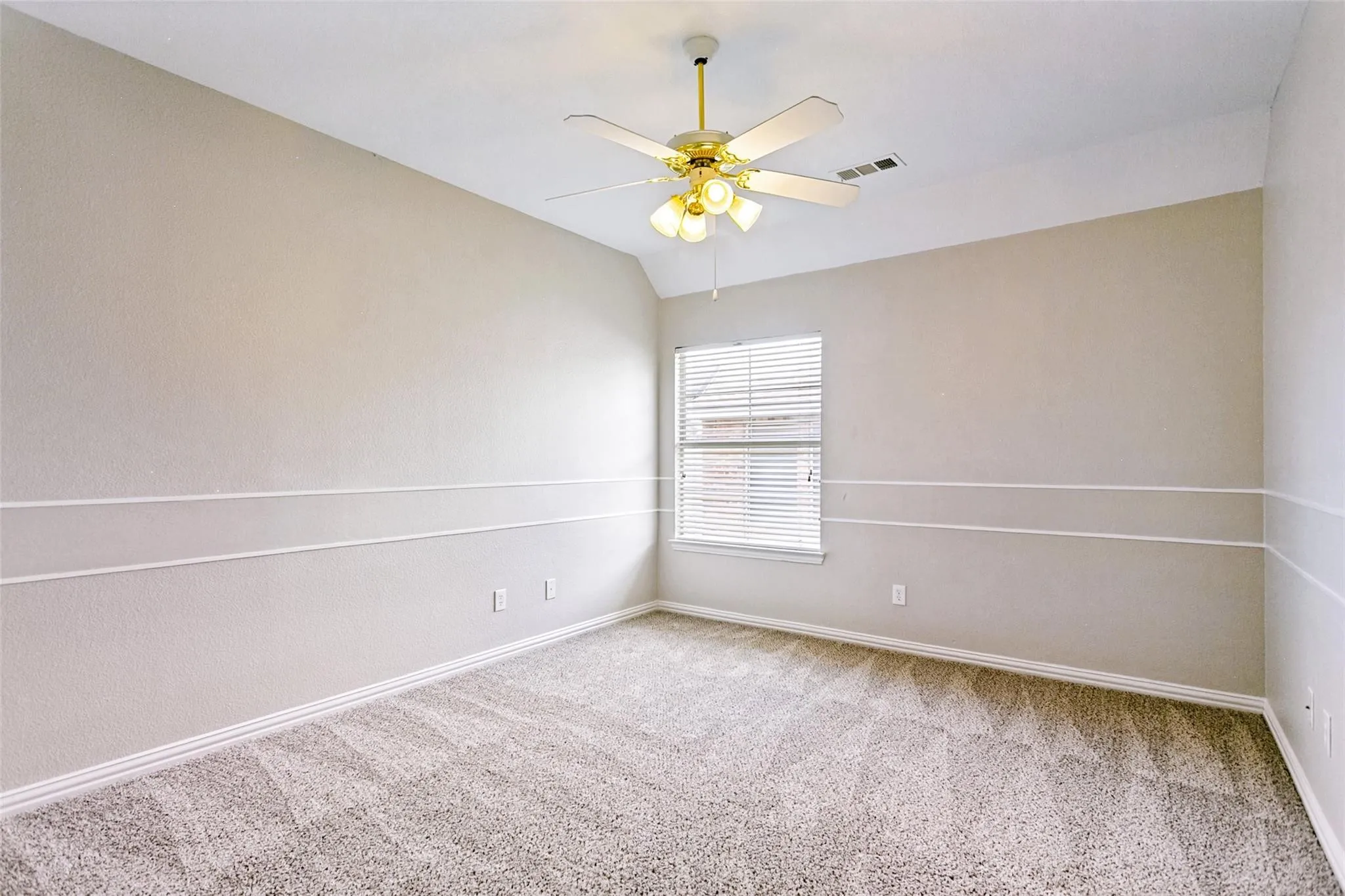 Textured wall finish, decorative wall trim, window with blinds, ceiling fan with integrated lighting, and carpet flooring