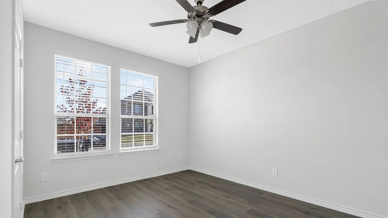 Dual pane windows, wood-finish flooring, ceiling fan, and white painted walls