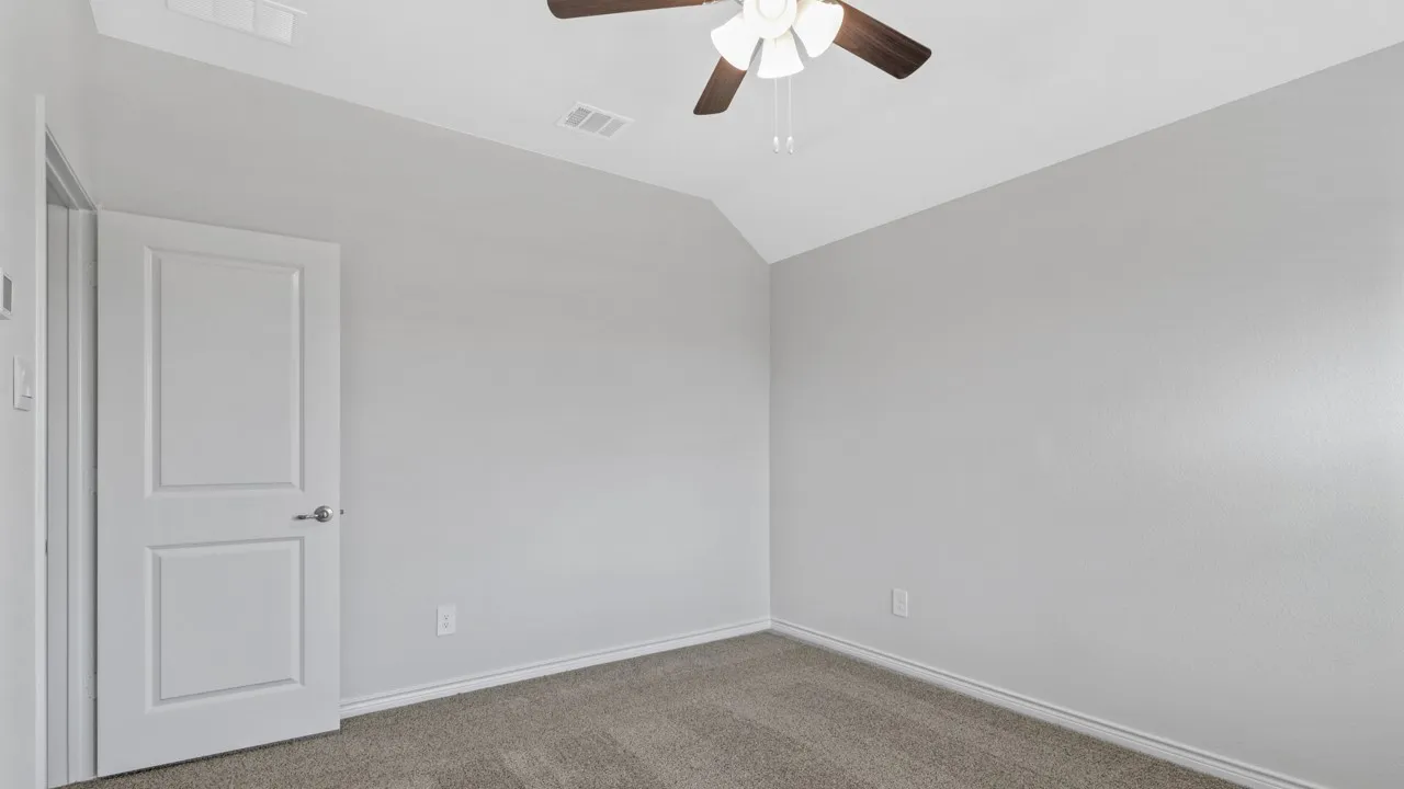 Neutral wall color, vaulted ceiling, ceiling fan, and carpeted flooring
