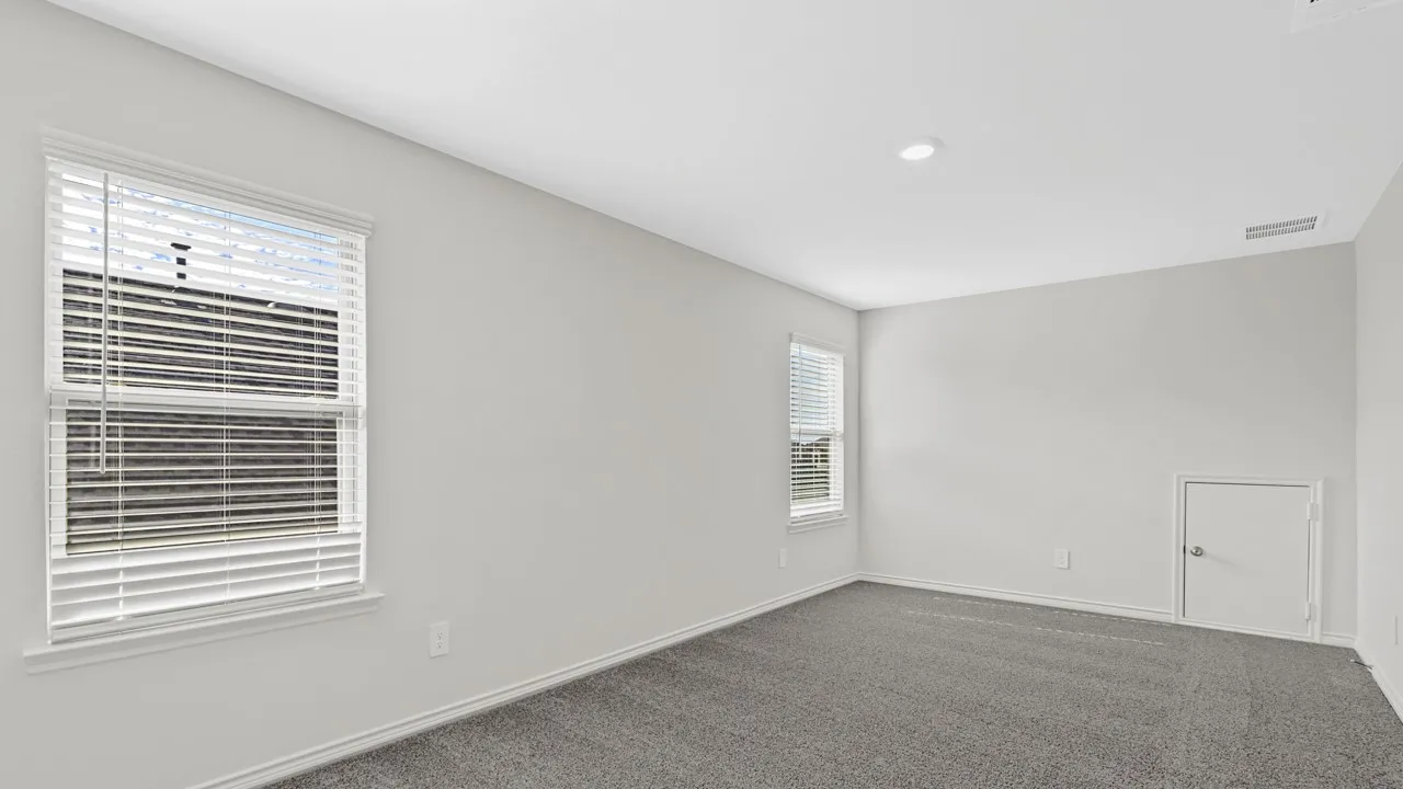 Recessed lighting, light gray wall finishes, gray carpeting, and multiple windows with blinds