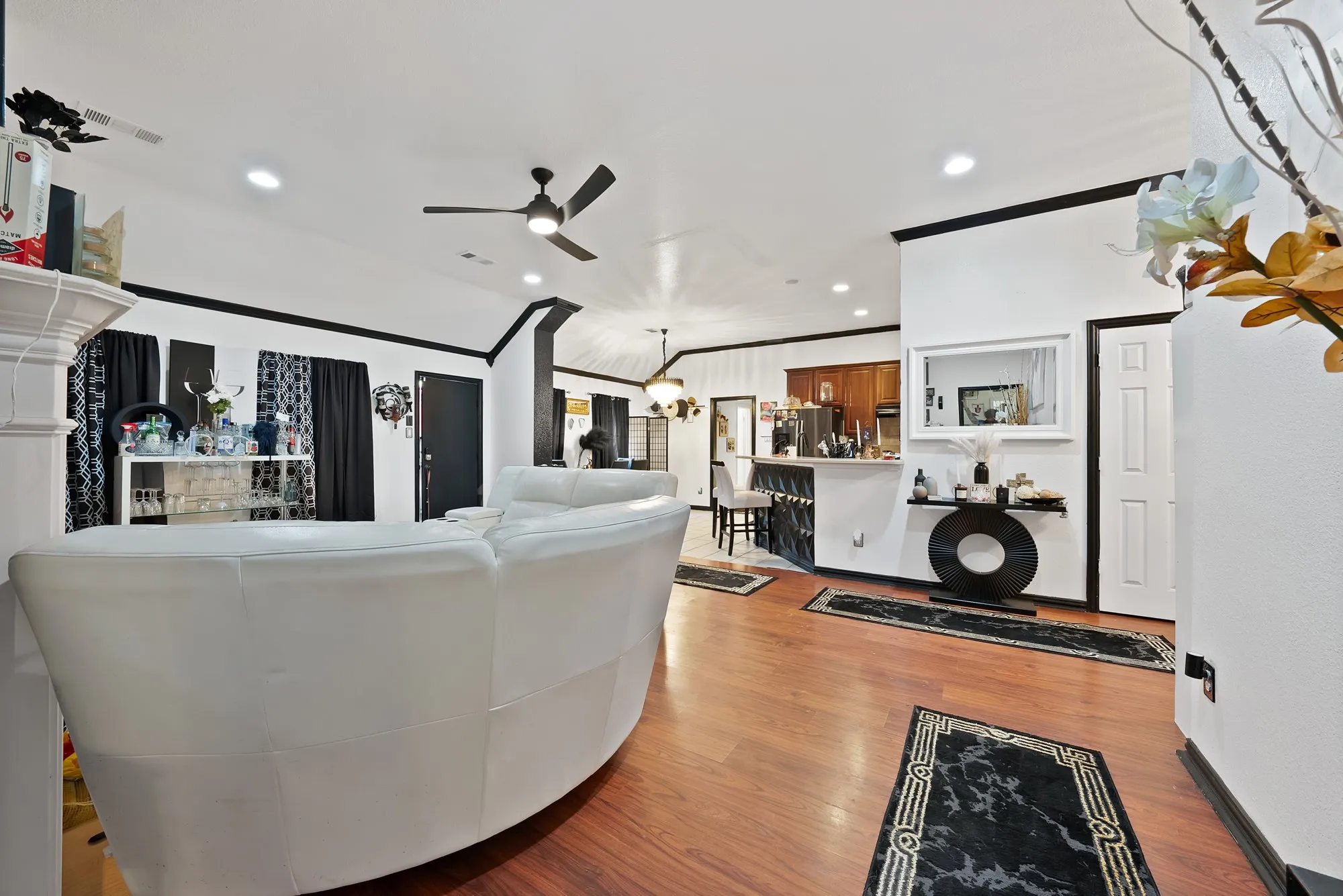 Wood-finish flooring throughout, recessed lighting, and a ceiling fan