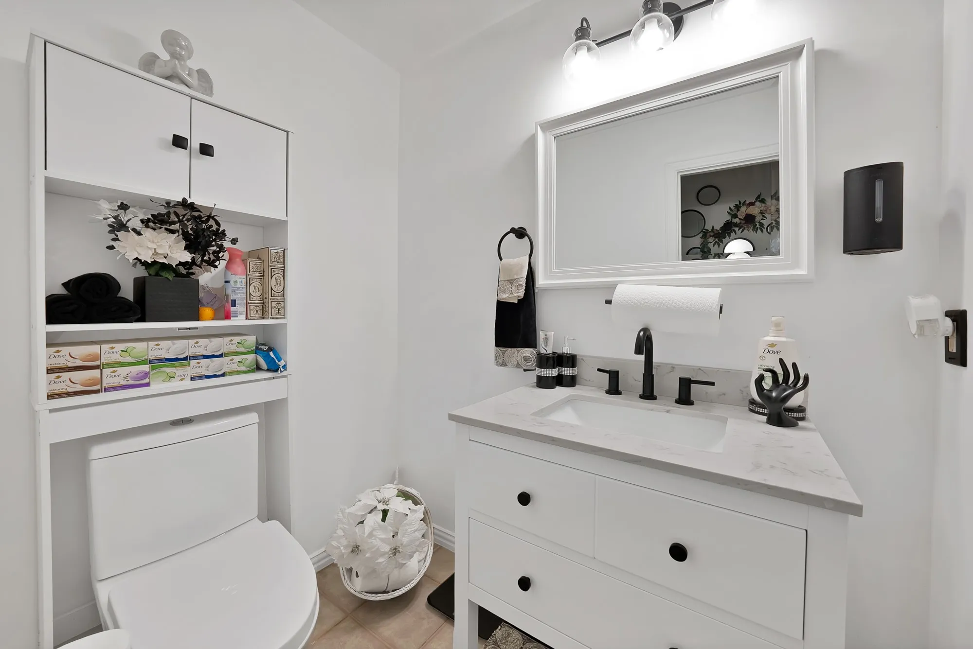 White vanity with an integrated sink, matte black faucet, and a light-colored countertop