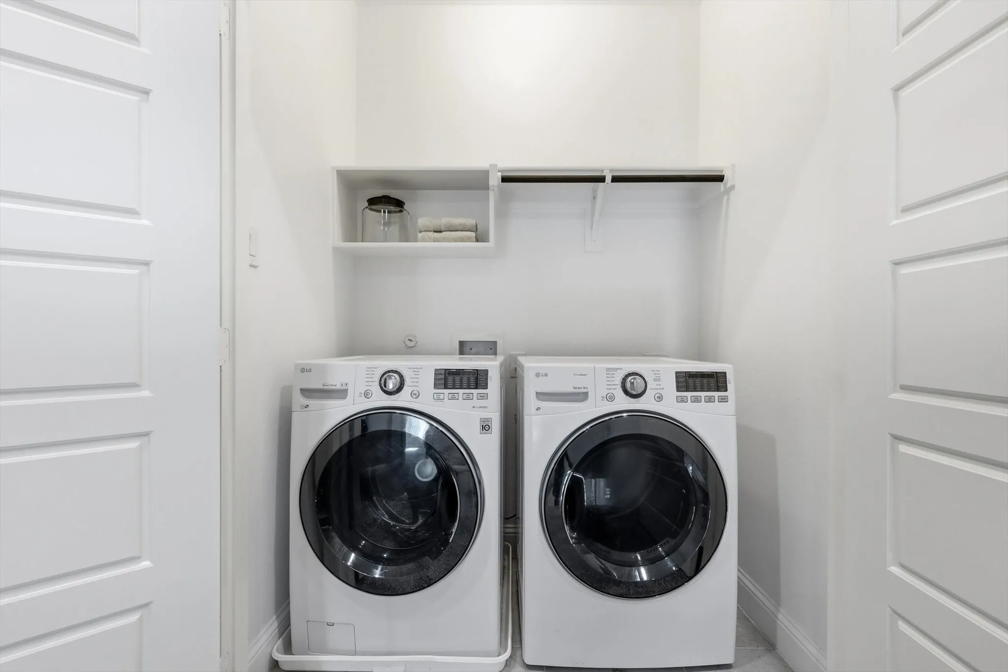 Laundry closet with built-in shelving and hanging rod