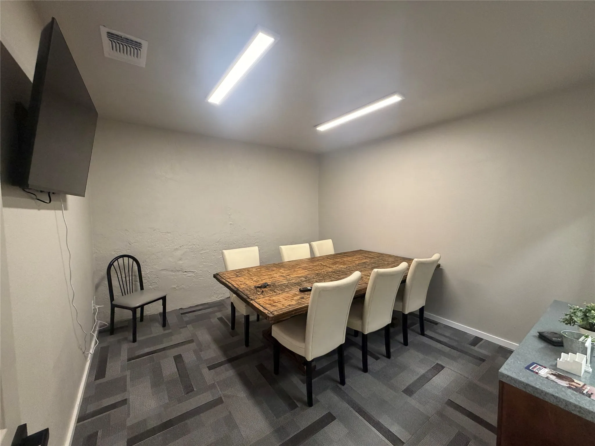 Conference room featuring a wall-mounted flat-screen television