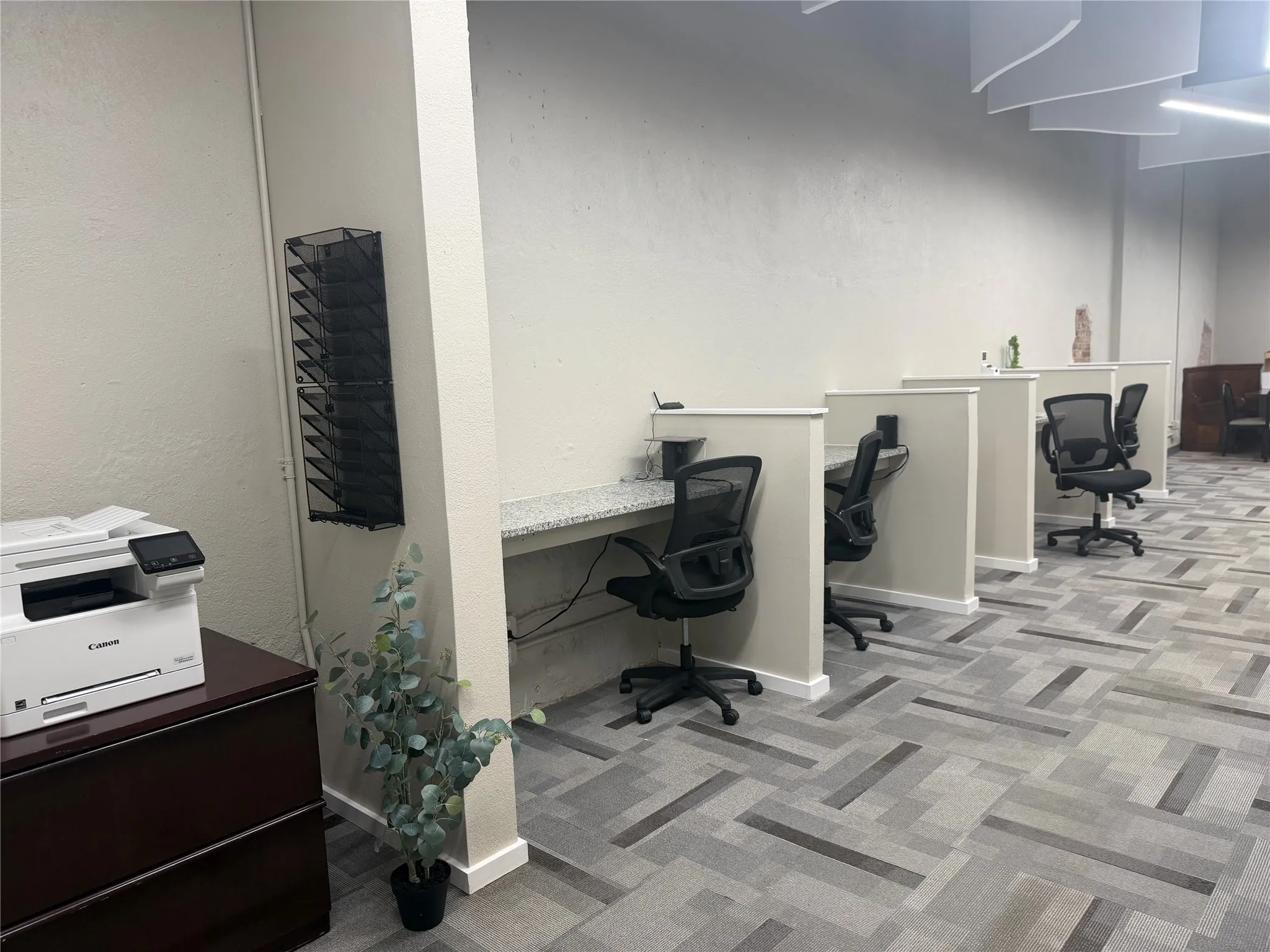 Individual workstations with granite-finish countertops