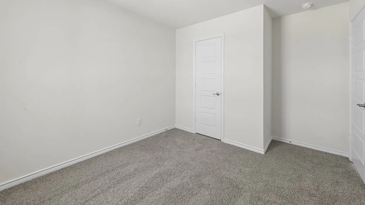 Neutral wall paint, gray carpet flooring, and white paneled doors