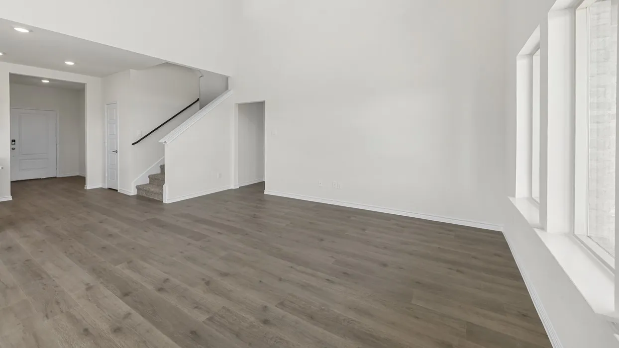 Wood-finish flooring throughout, bright white walls, and multi-pane windows