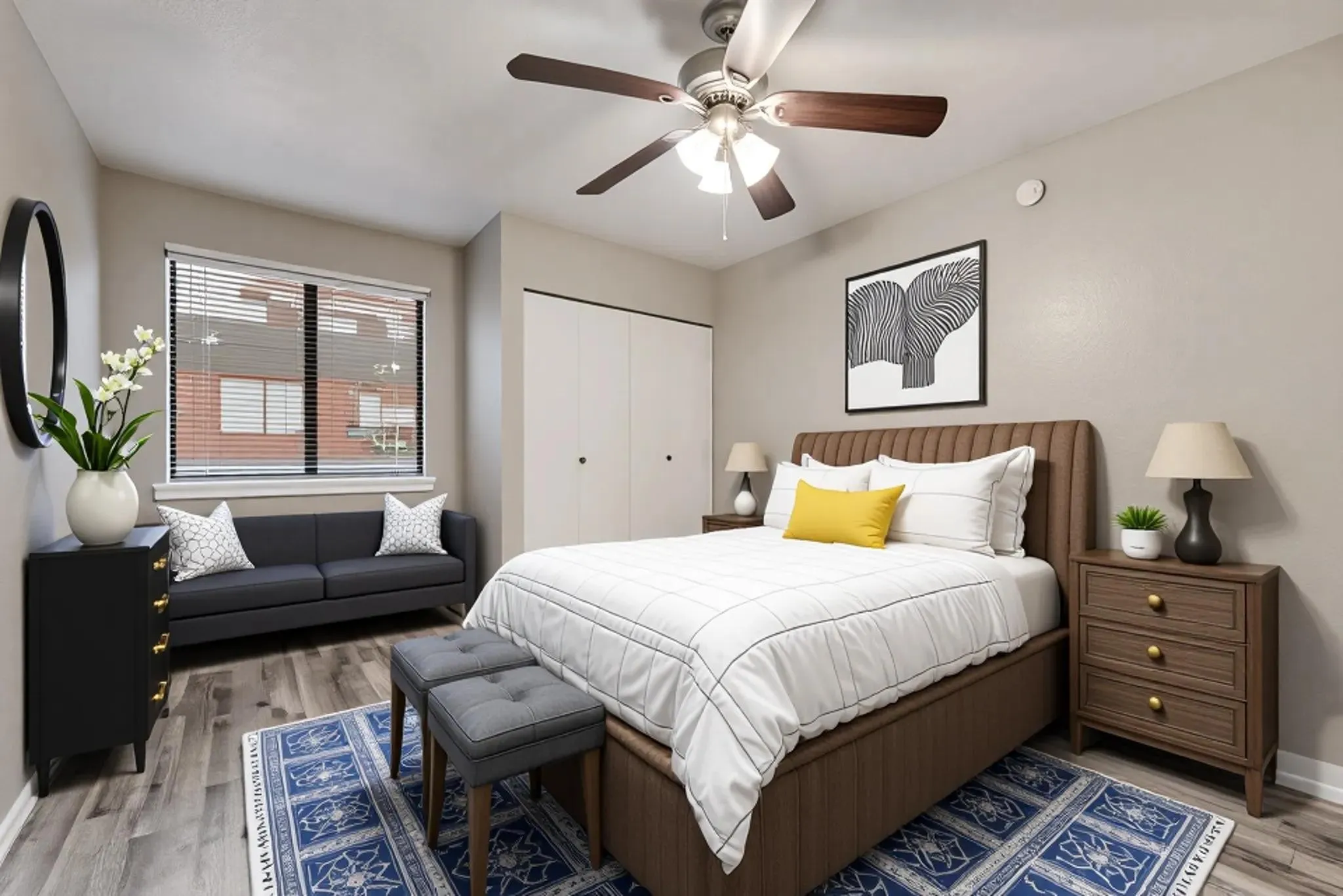 Wood-finish flooring, ceiling fan with integrated lighting, window with blinds, and built-in closet with bifold doors